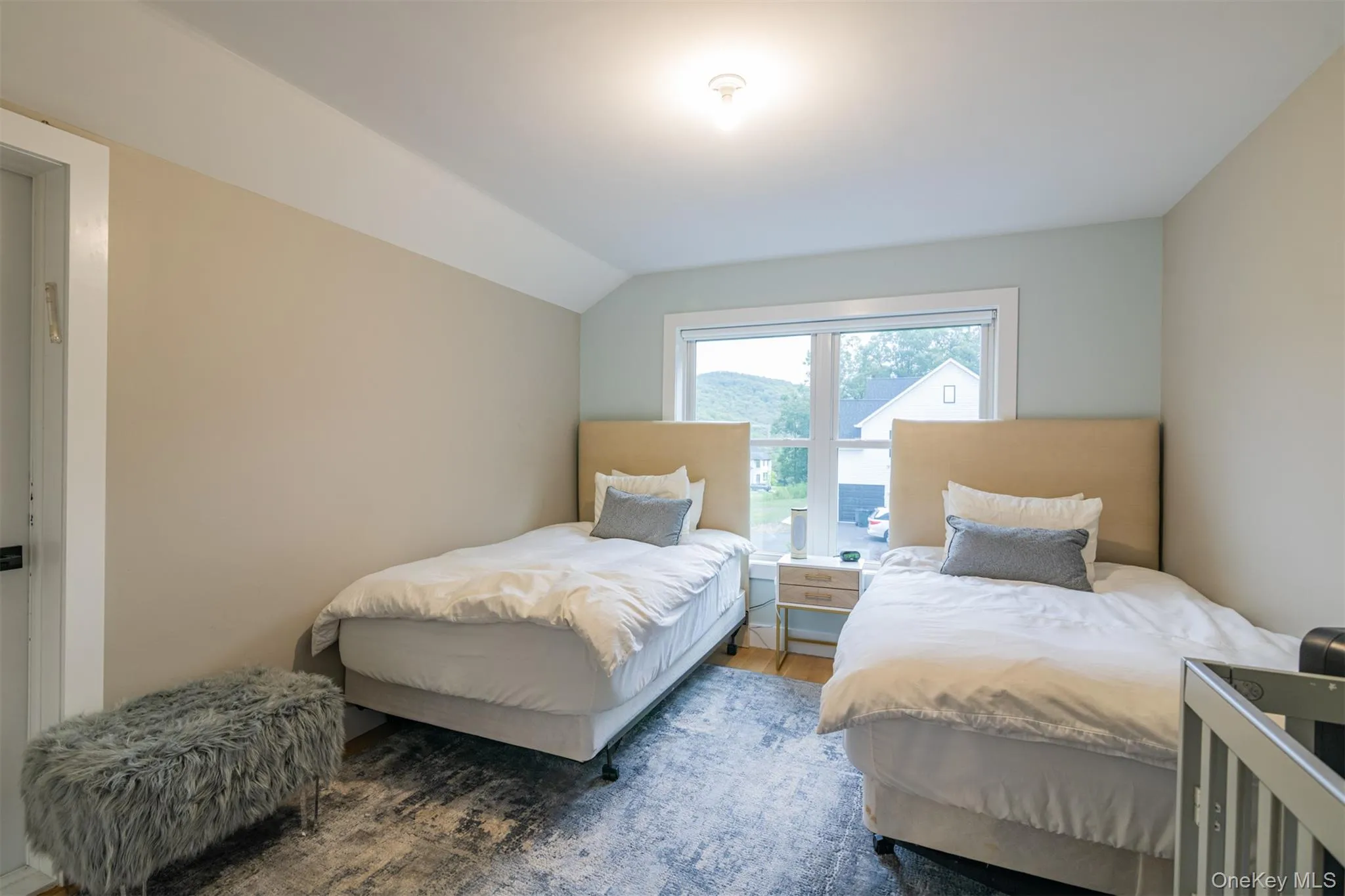 Bedroom featuring wood finished floors and lofted ceiling Bedroom featuring wood finished floors and lofted ceiling