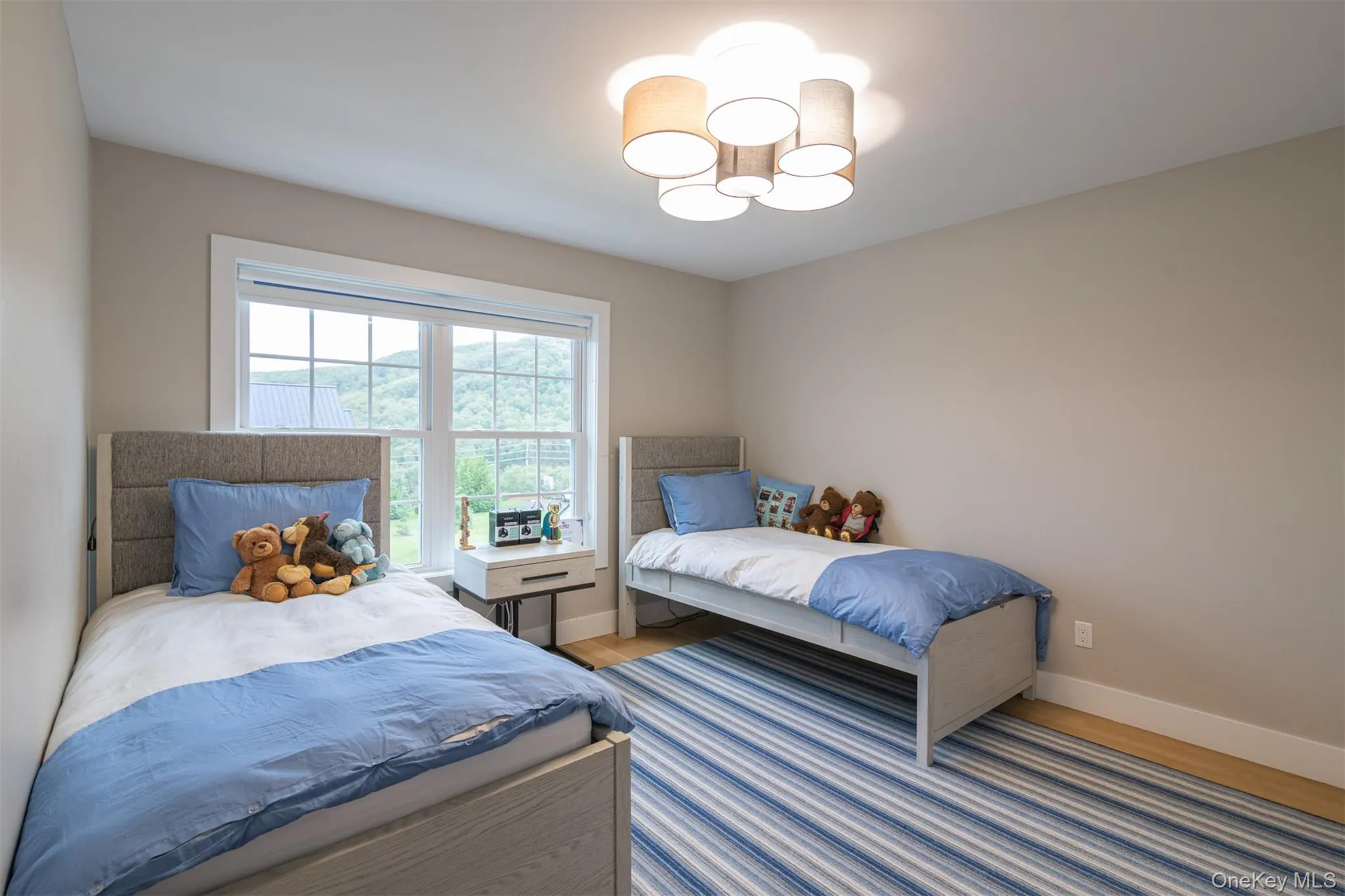 Bedroom with wood finished floors and a chandelier Bedroom with wood finished floors and a chandelier