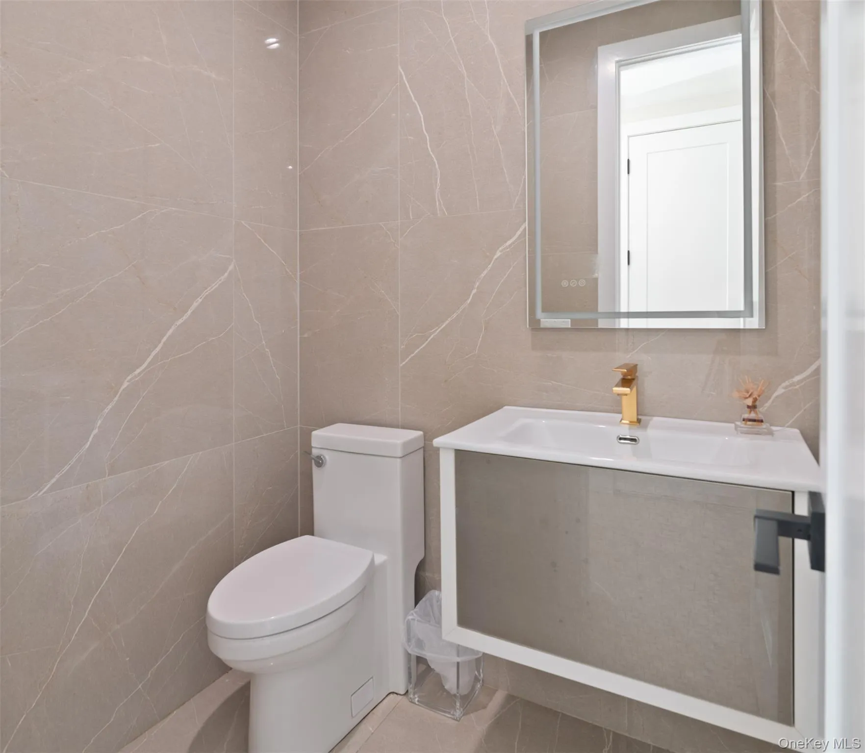 Bathroom featuring vanity and tile walls Bathroom featuring vanity and tile walls