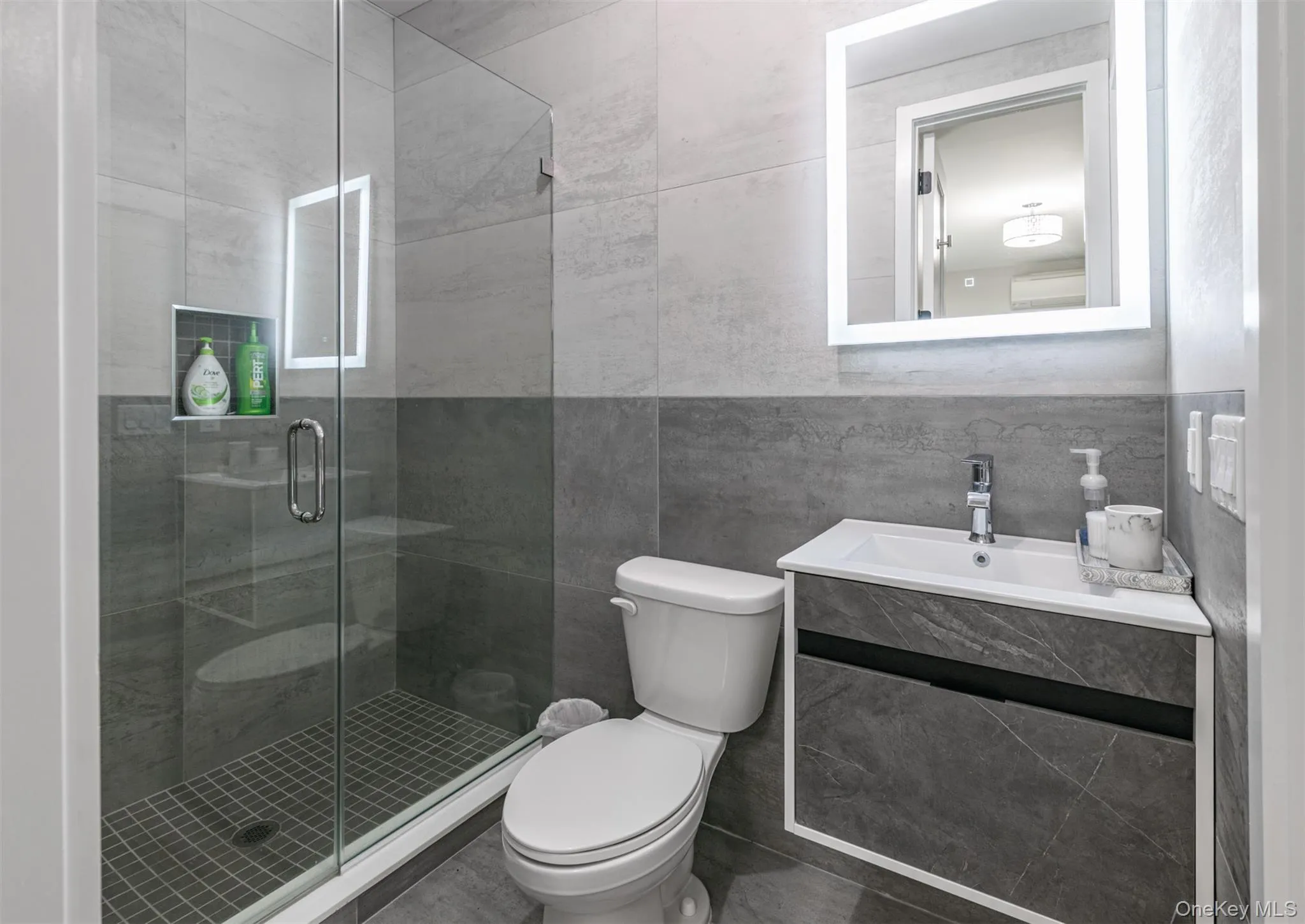 Full bath with tile walls, a stall shower, and vanity Full bath with tile walls, a stall shower, and vanity