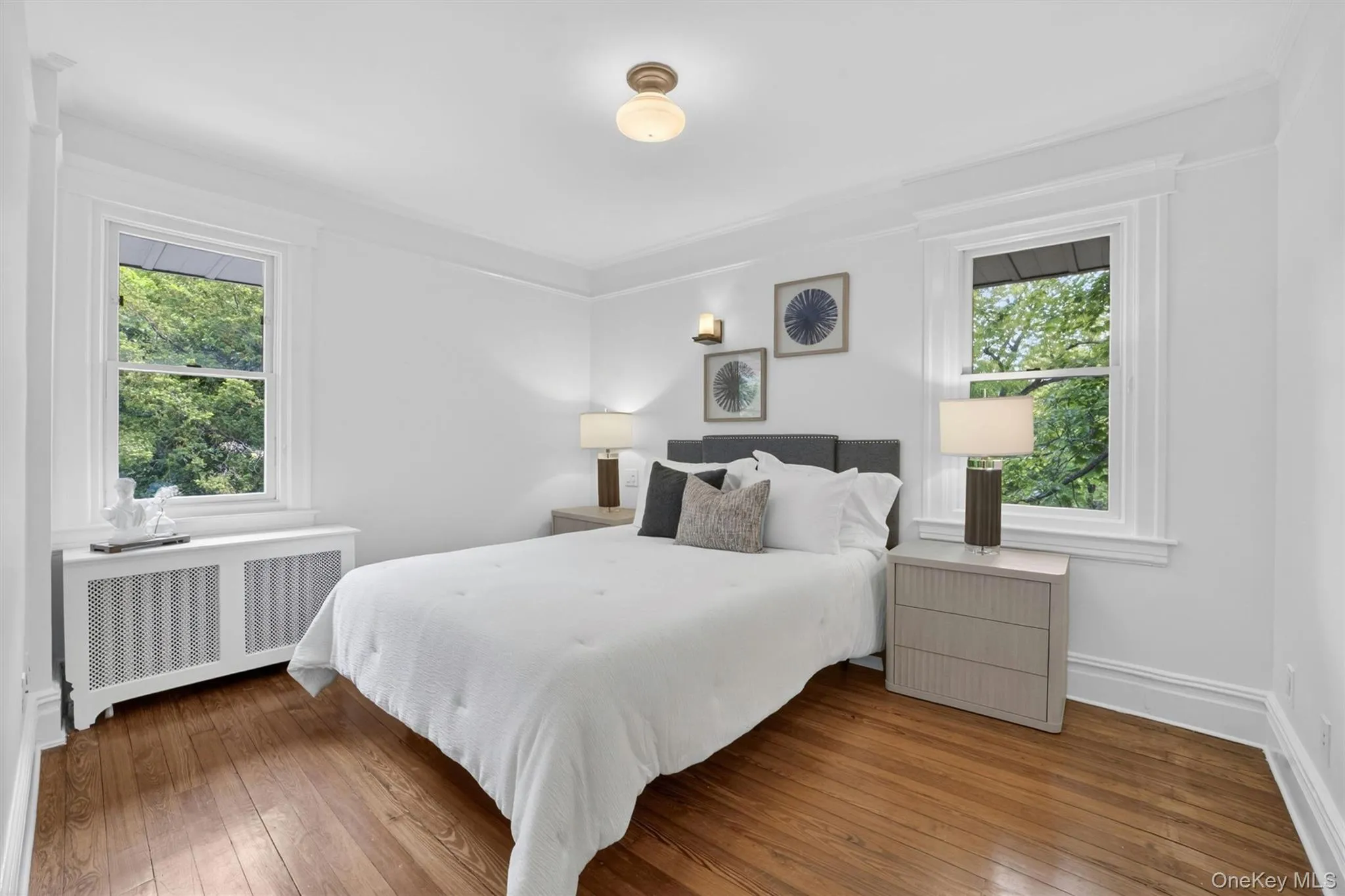 Hardwood flooring, crown molding, and bright white walls define this room Hardwood flooring, crown molding, and bright white walls define this room