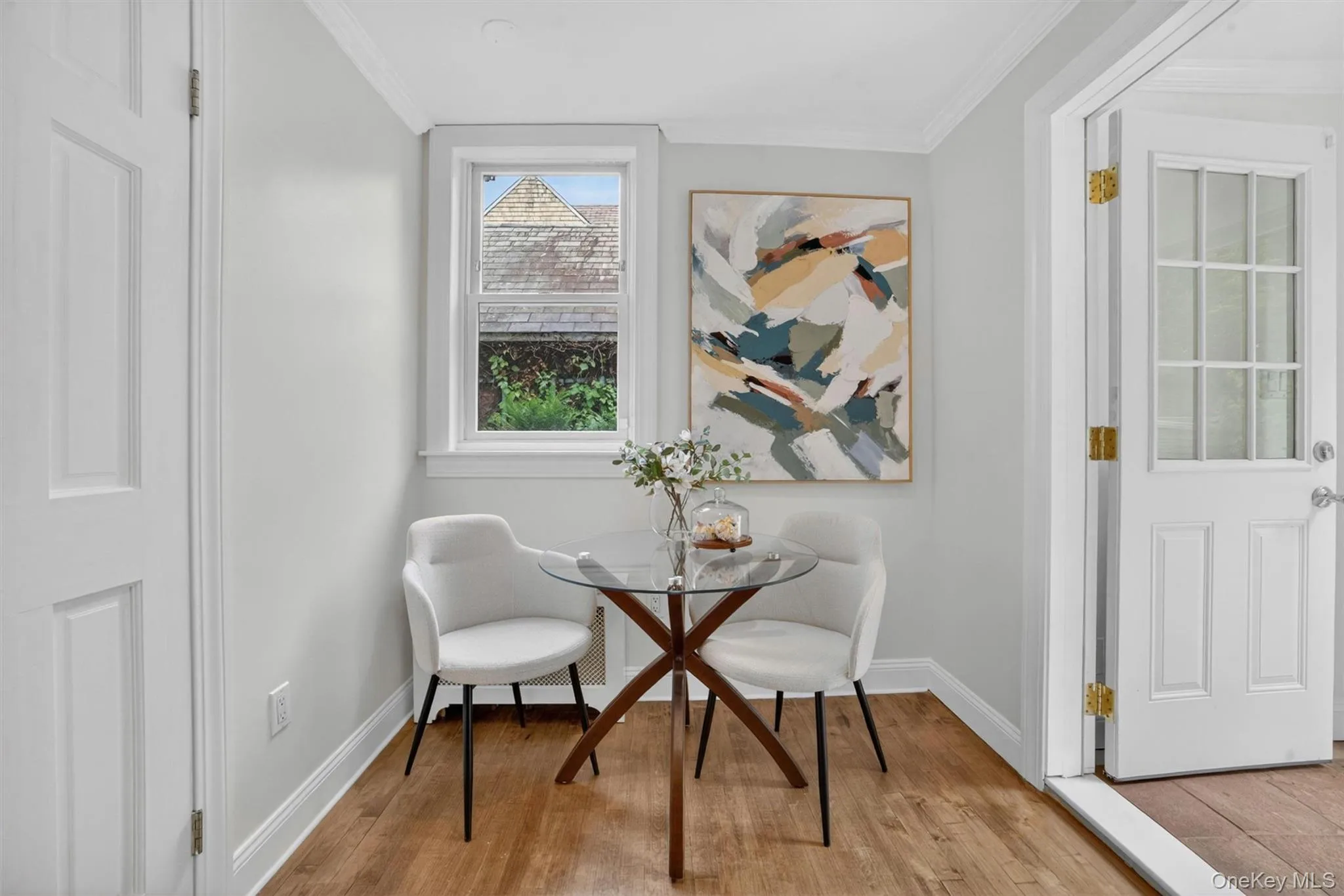 Interior space featuring wood-finish flooring and crown molding Interior space featuring wood-finish flooring and crown molding