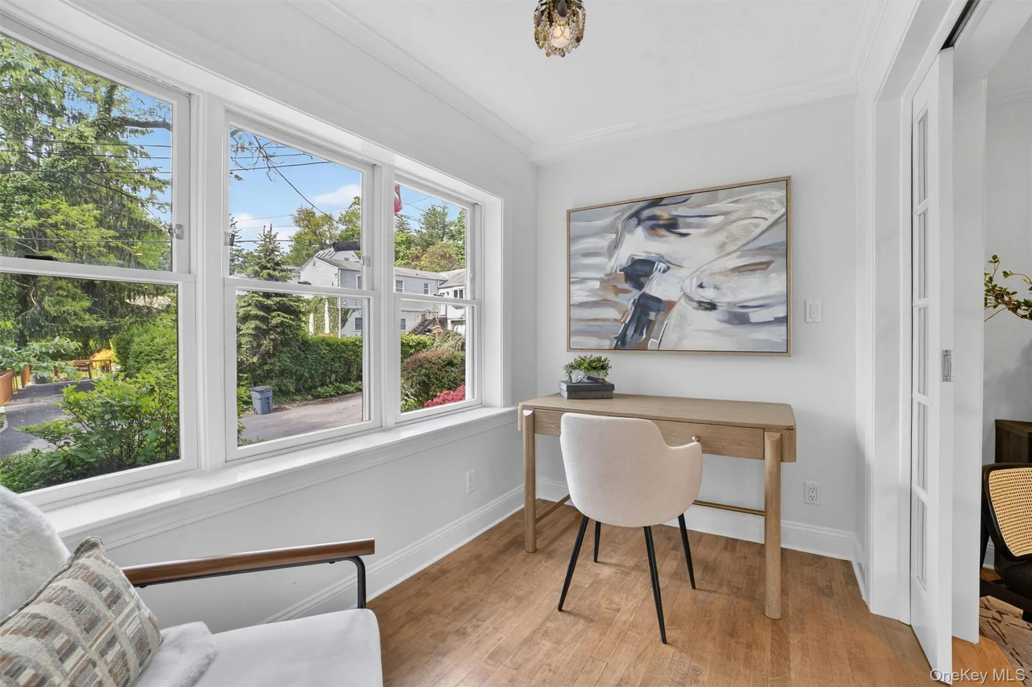 Bright room with expansive windows and wood-finish flooring Bright room with expansive windows and wood-finish flooring