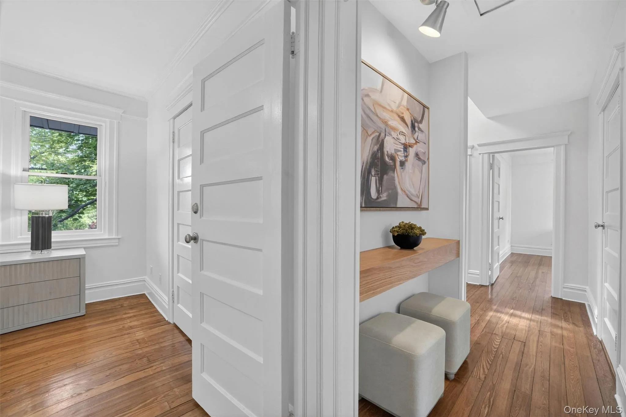 Hardwood flooring extending throughout, complemented by white trim and five-panel doors Hardwood flooring extending throughout, complemented by white trim and five-panel doors