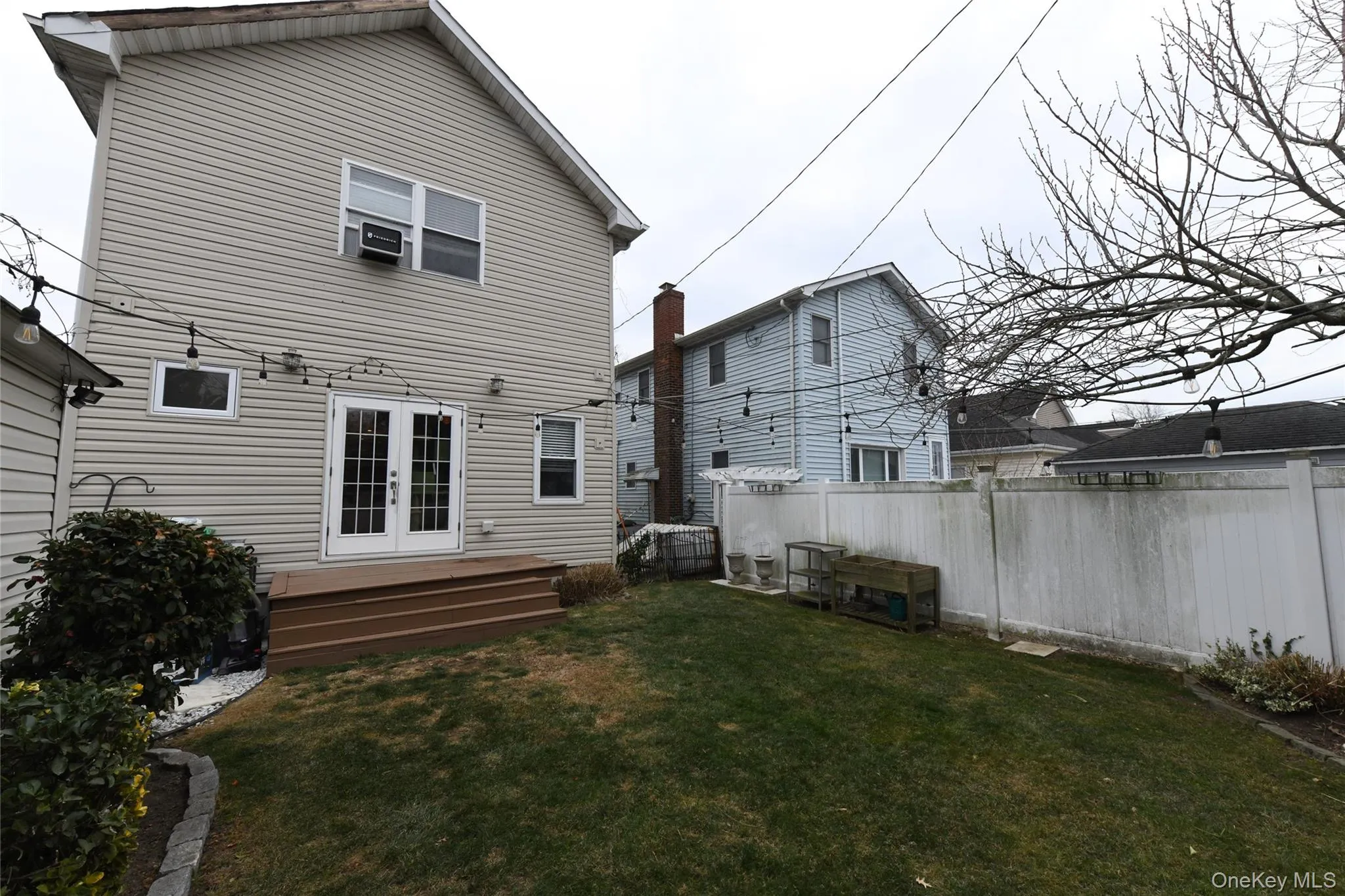 Rear view of house with a deck and french doors Rear view of house with a deck and french doors