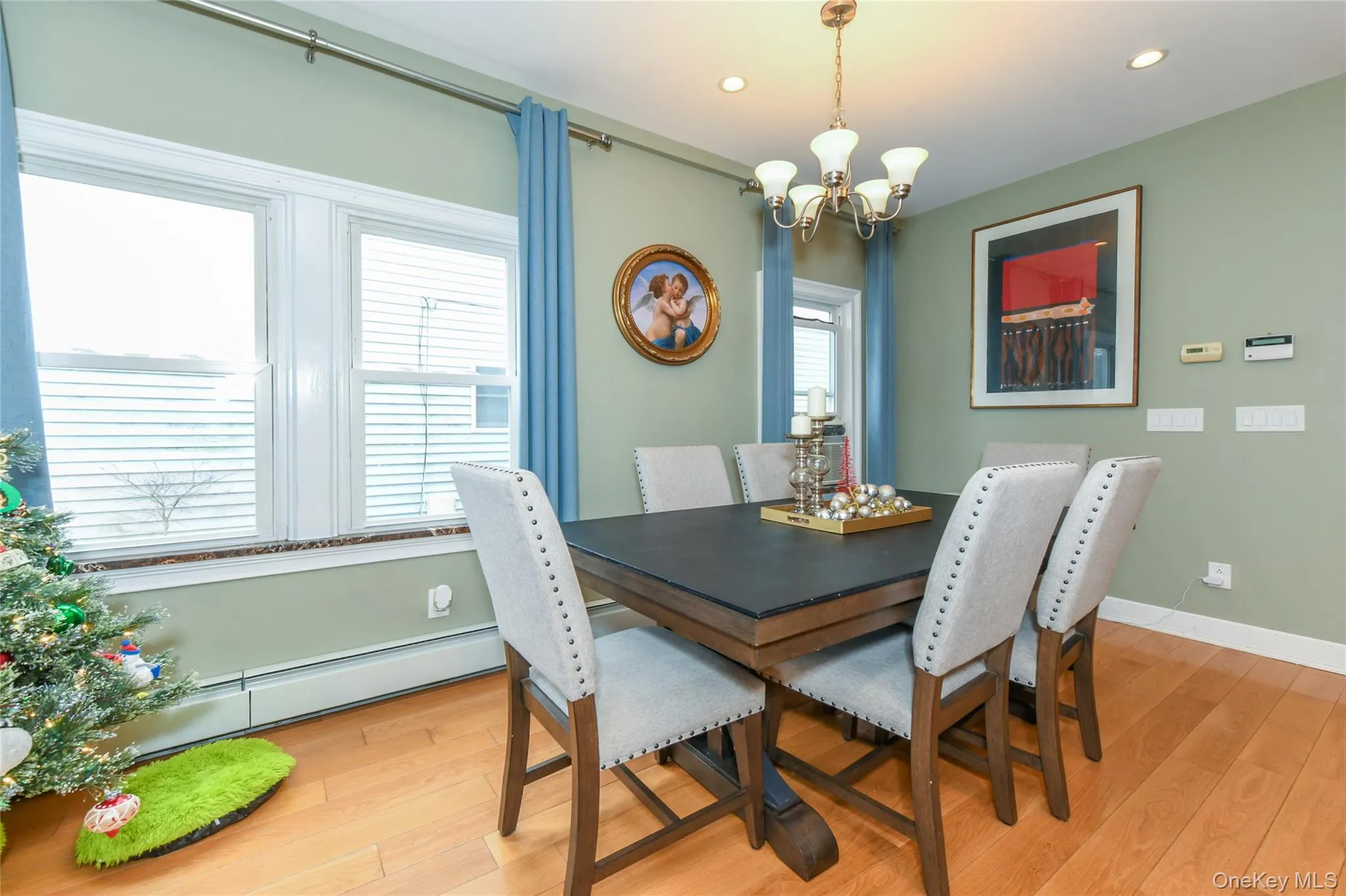Dining space with a chandelier, a baseboard radiator, light wood finished floors, healthy amount of natural light, and recessed lighting Dining space with a chandelier, a baseboard radiator, light wood finished floors, healthy amount of natural light, and recessed lighting