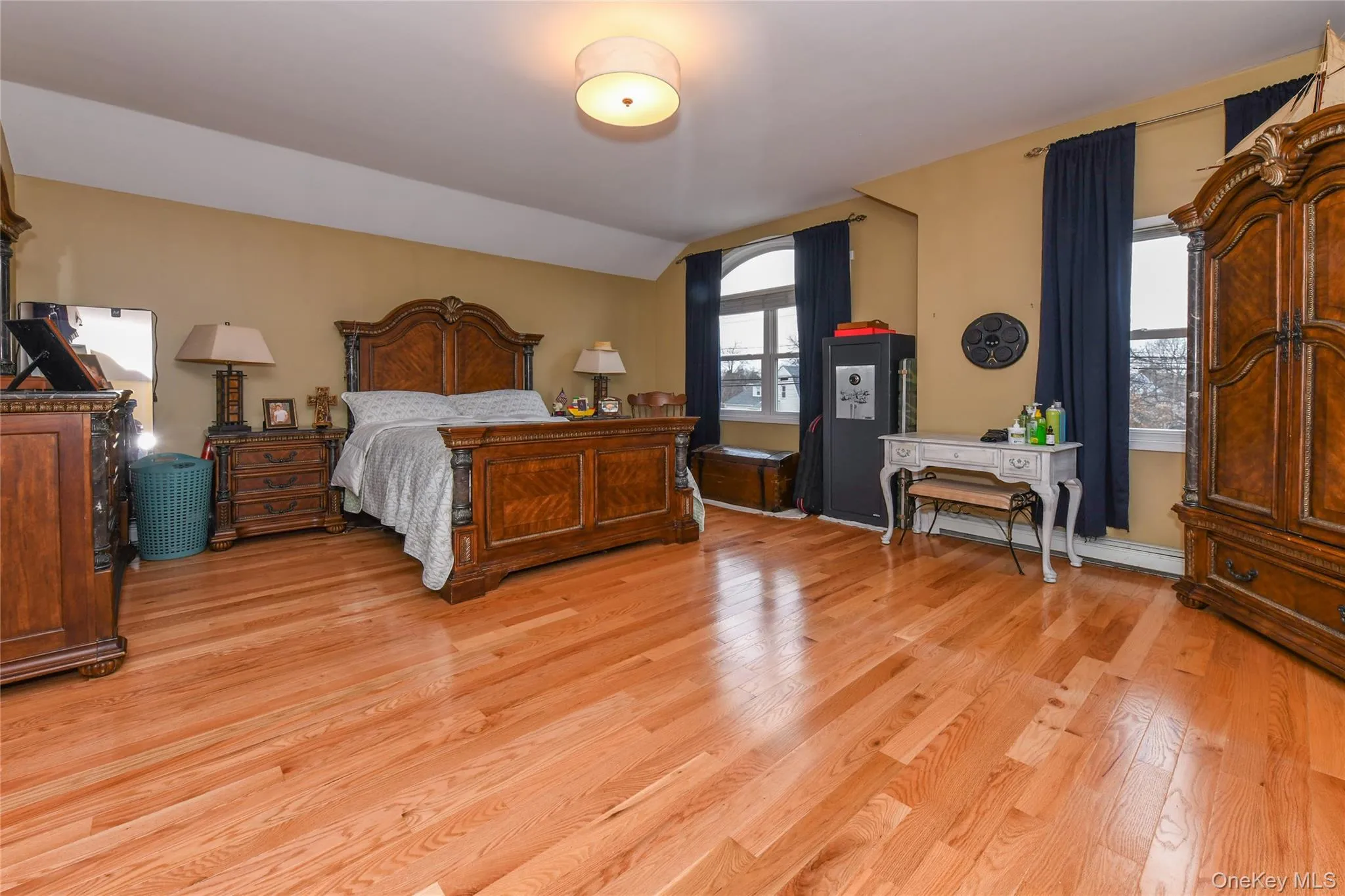 Bedroom with light wood finished floors and lofted ceiling Bedroom with light wood finished floors and lofted ceiling