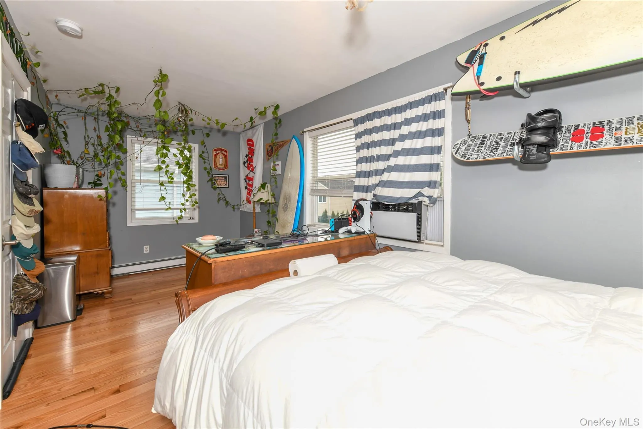 Bedroom featuring light wood-type flooring and a baseboard radiator Bedroom featuring light wood-type flooring and a baseboard radiator