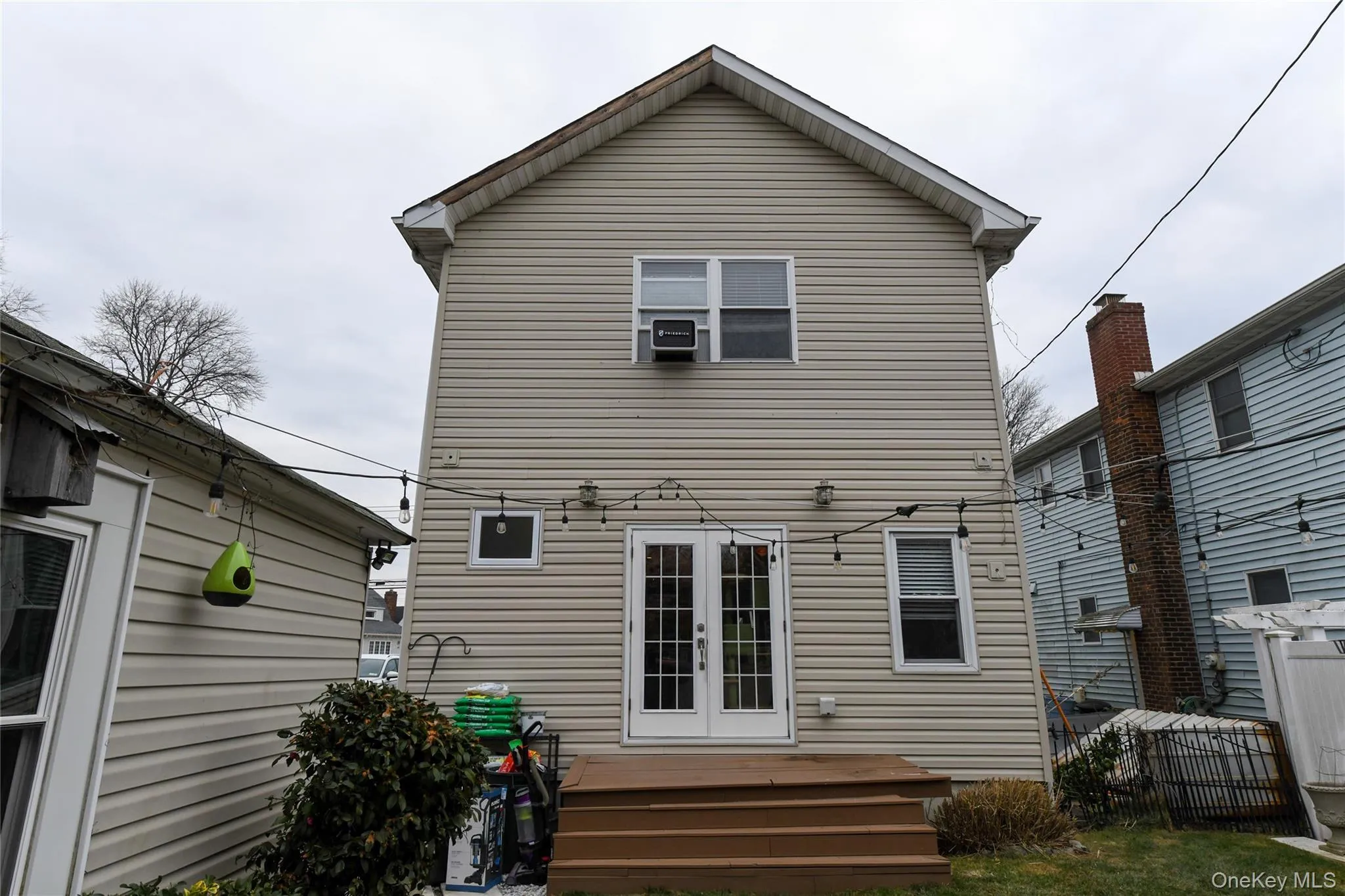 Back of property featuring a wooden deck and french doors Back of property featuring a wooden deck and french doors