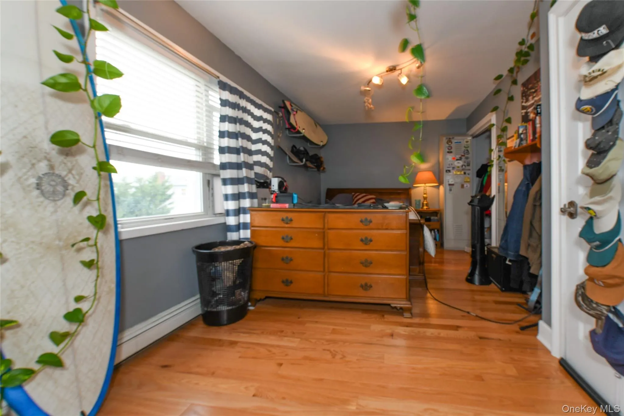 Bedroom featuring a baseboard heating unit and light wood-style flooring Bedroom featuring a baseboard heating unit and light wood-style flooring