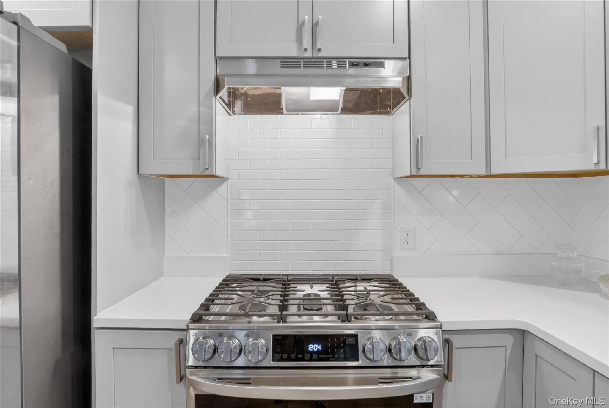 Horizontal subway tiled look backsplash over the stove with a custom design to diagonal subway tile for the remainder of the backsplash. Horizontal subway tiled look backsplash over the stove with a custom design to diagonal subway tile for the remainder of the backsplash.
