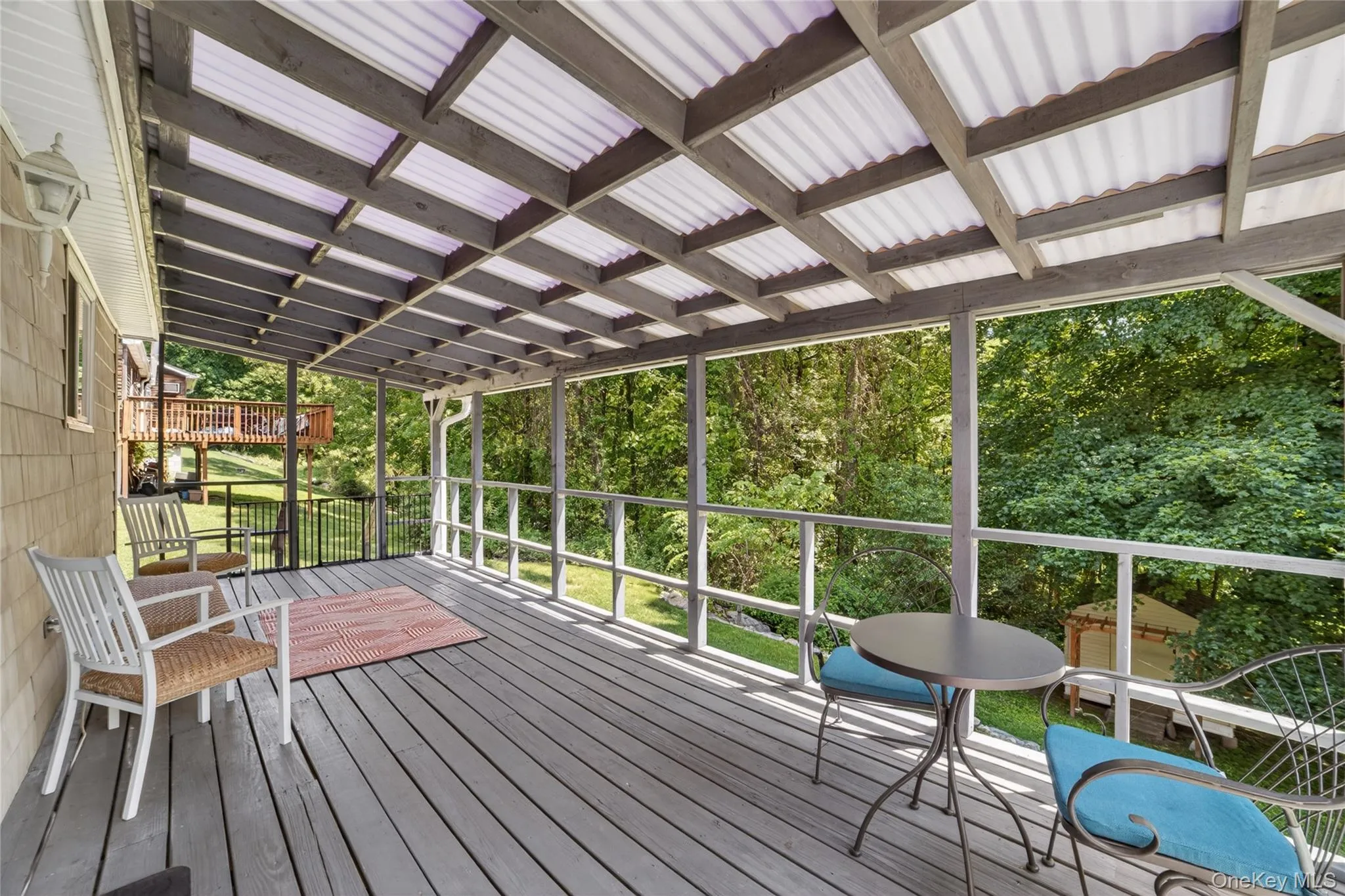 Relax on this long spacious deck and enjoy the greenery. Relax on this long spacious deck and enjoy the greenery.