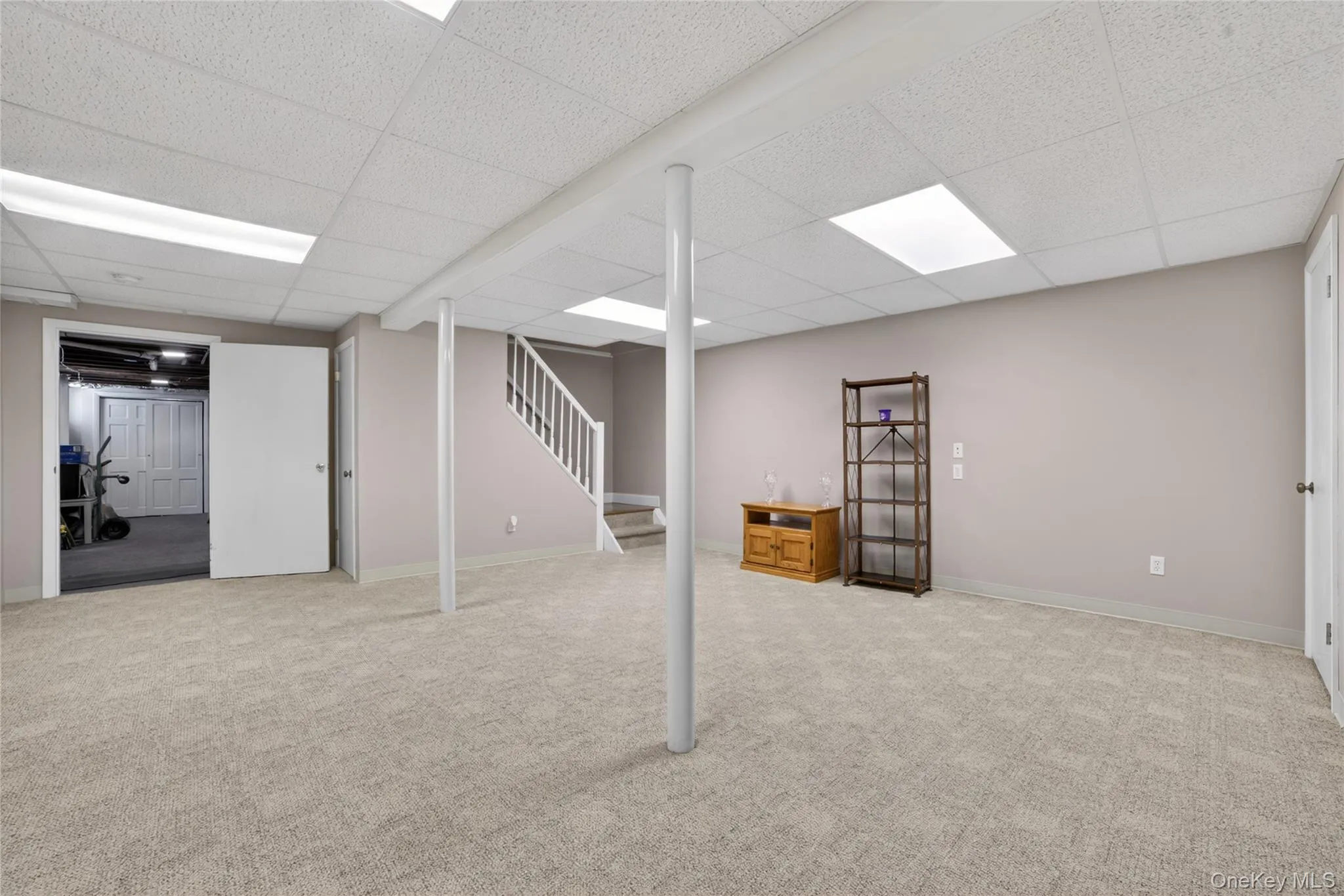 Front room of the basement opens to the storage/utility room. Front room of the basement opens to the storage/utility room.