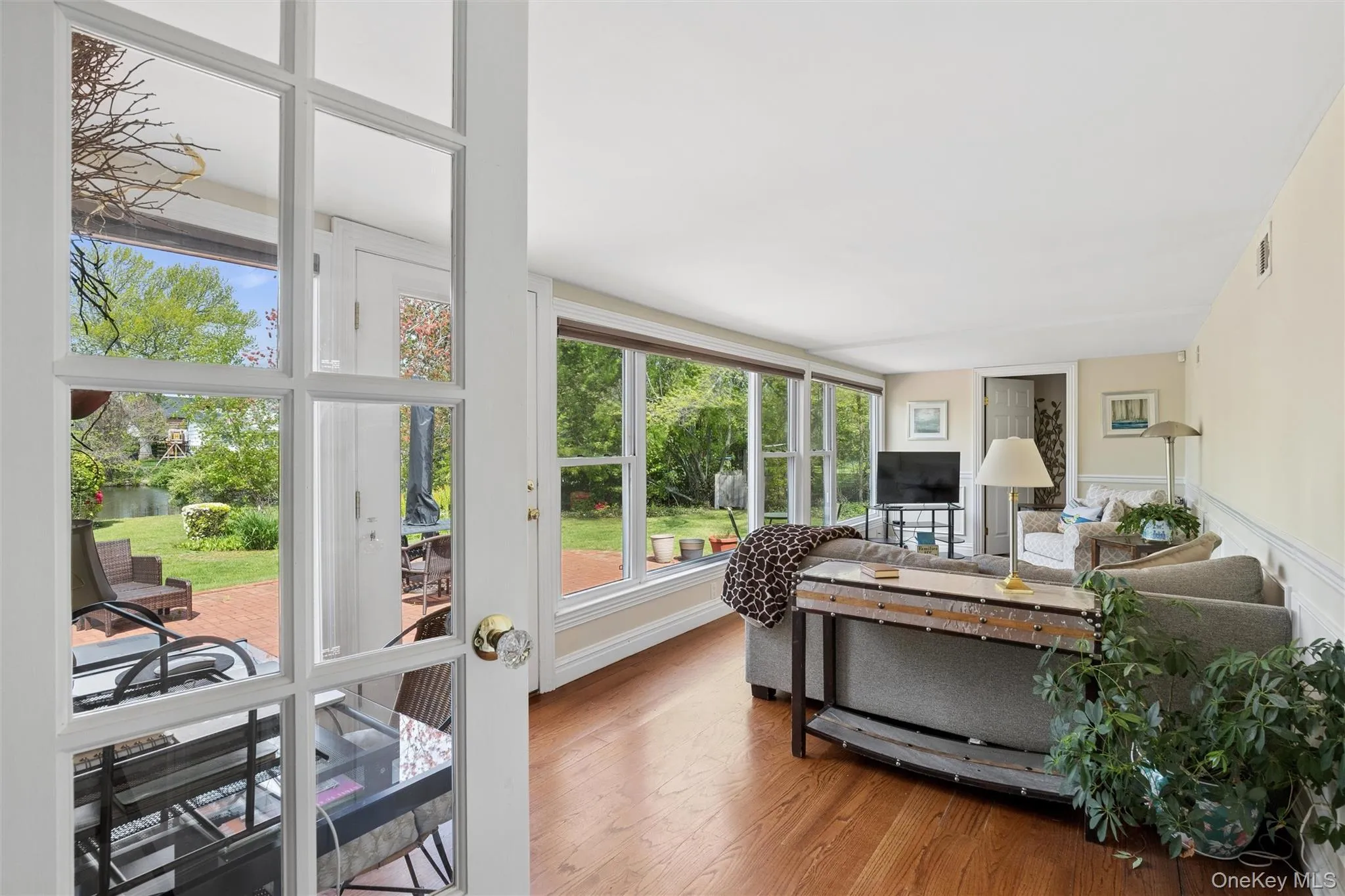 This 4 Season Sunroom is a relaxing retreat with beautiful hardwood floors, a full bank of windows to enjoy the outside gardens and pond views. Plus a work area for those who work from home. This 4 Season Sunroom is a relaxing retreat with beautiful hardwood floors, a full bank of windows to enjoy the outside gardens and pond views. Plus a work area for those who work from home.
