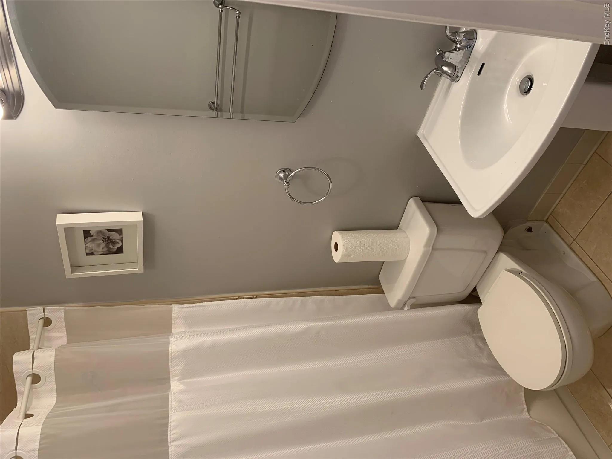 Bathroom featuring a pedestal sink with chrome faucet, a standard toilet, and tiled flooring Bathroom featuring a pedestal sink with chrome faucet, a standard toilet, and tiled flooring