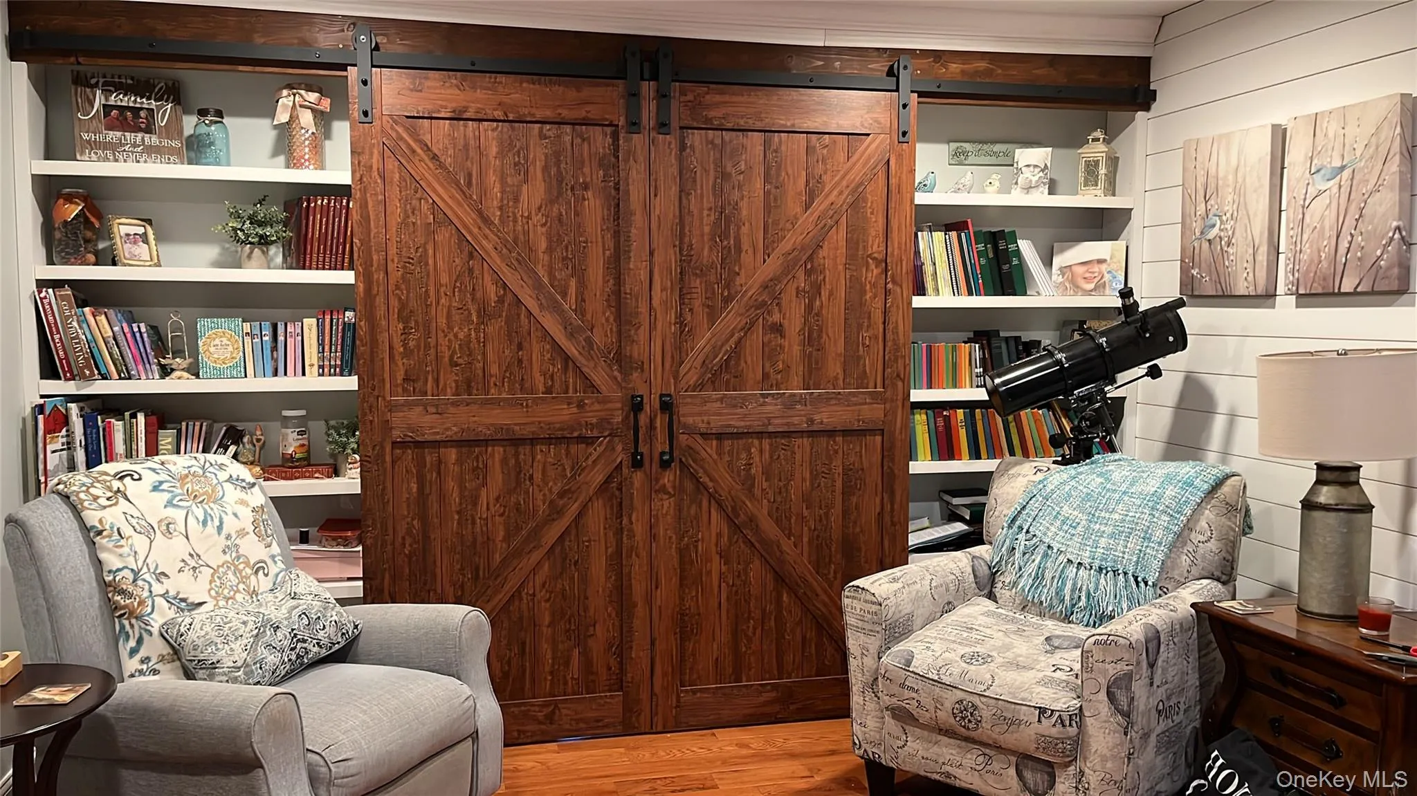 Custom Built in book shelves with Barn doors leading to office. Custom Built in book shelves with Barn doors leading to office.