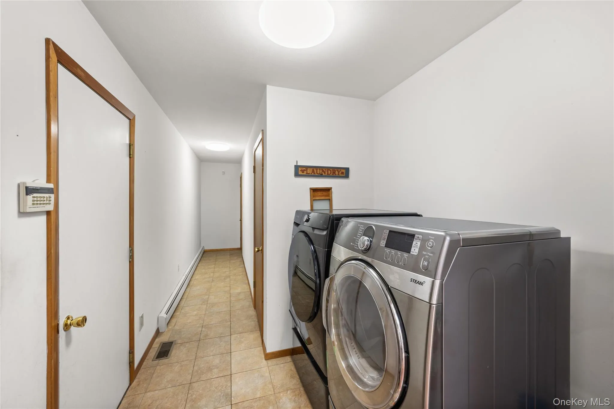 Laundry area, door to garage, and pantry area. Laundry area, door to garage, and pantry area.