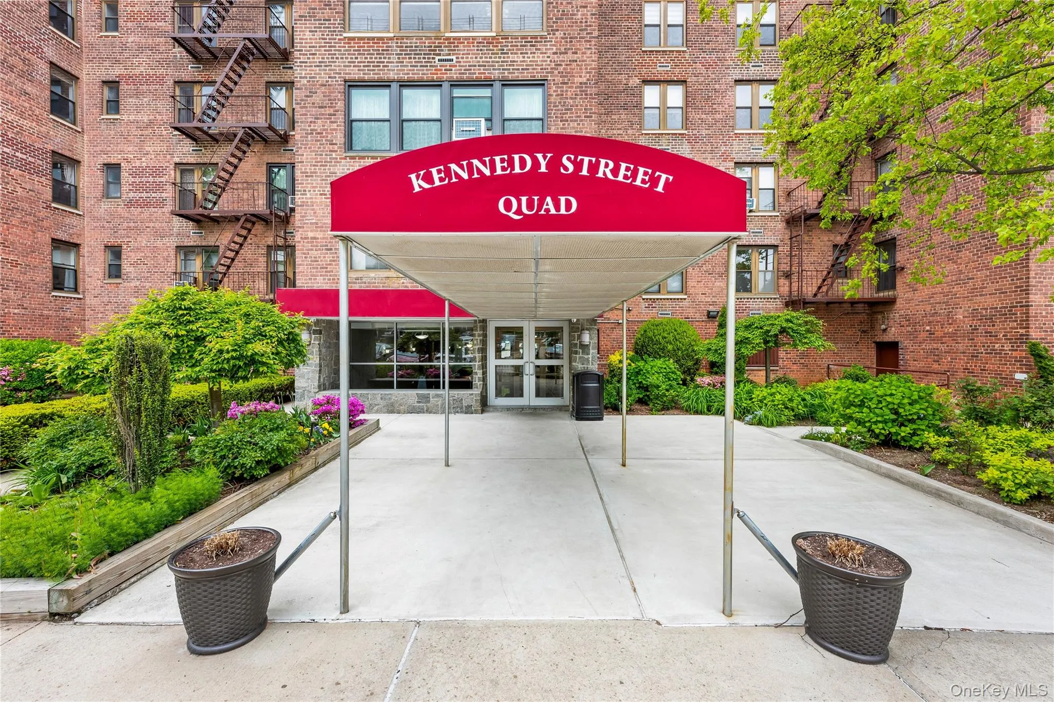 Brick facade building featuring a red canopy entrance Brick facade building featuring a red canopy entrance