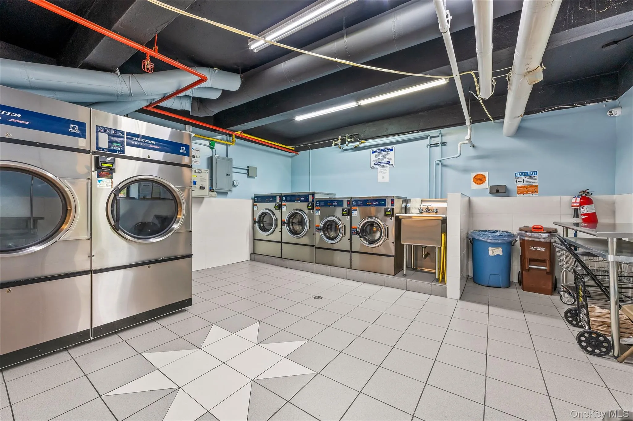 Dedicated laundry facility featuring multiple commercial-grade washers and dryers Dedicated laundry facility featuring multiple commercial-grade washers and dryers