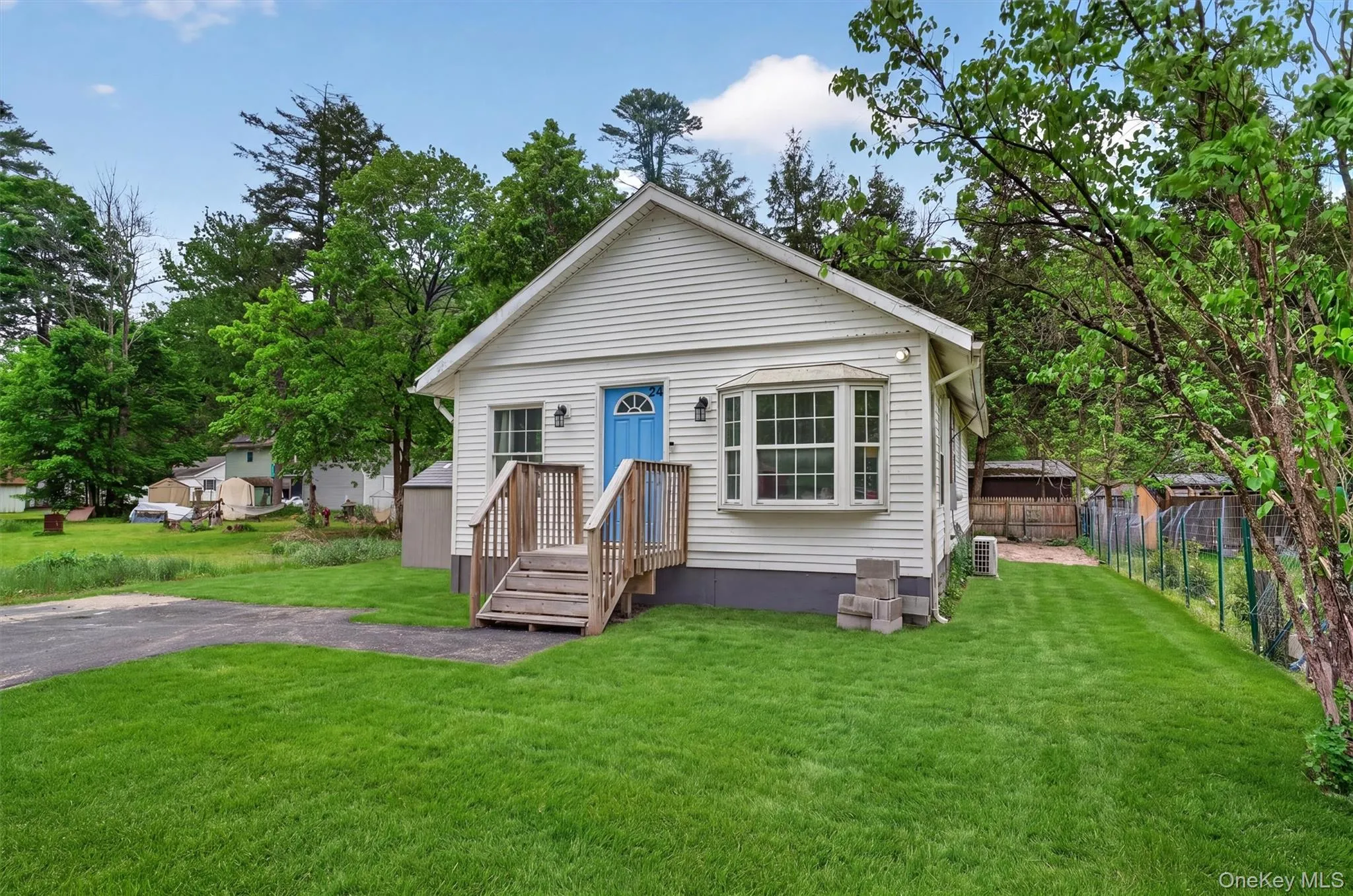 Cute Cottage with front lawn and newer paved driveway on left Cute Cottage with front lawn and newer paved driveway on left