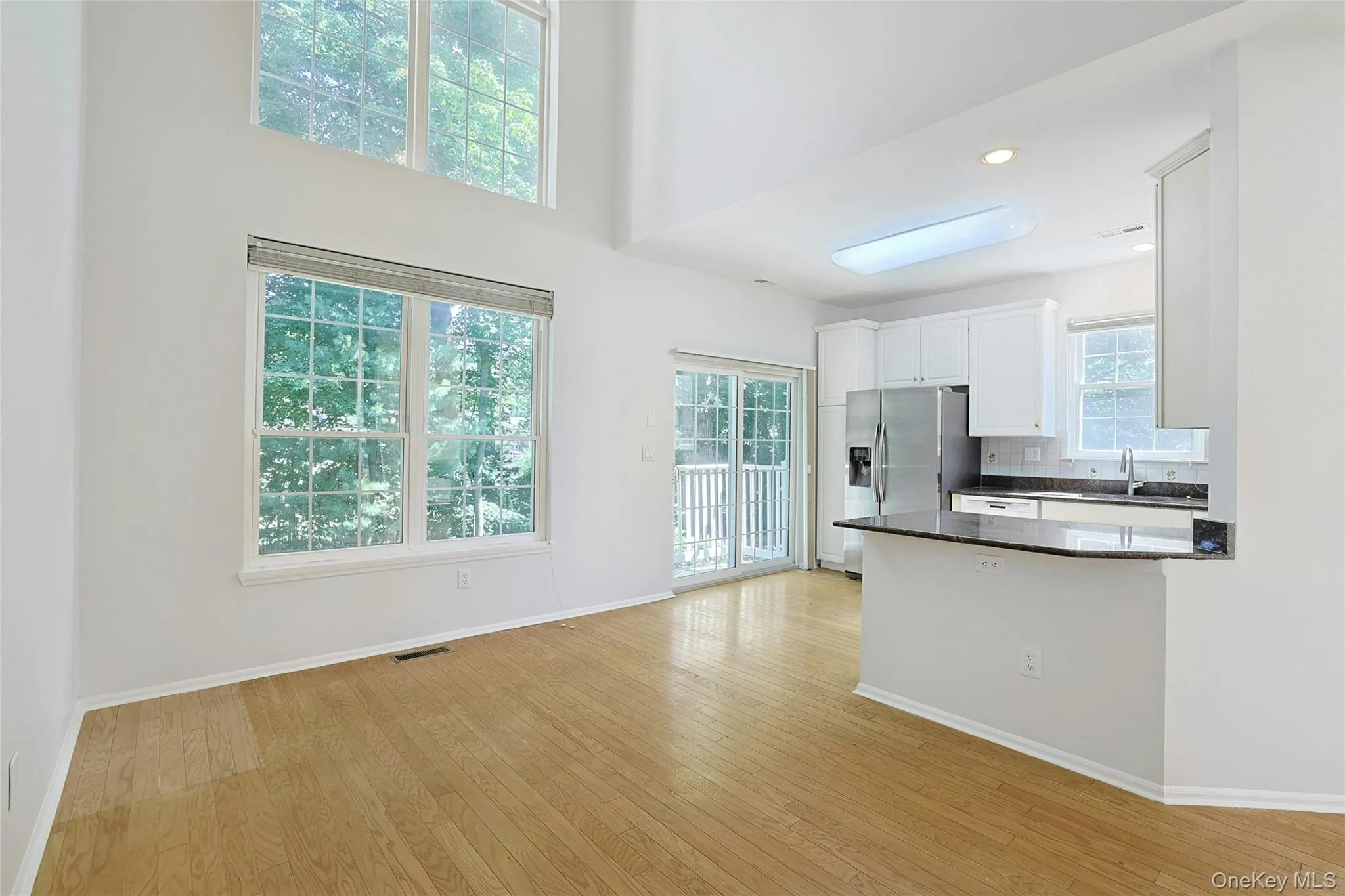 Bright kitchen with light cabinetry, peninsula and lots of windows. Access to private patio Bright kitchen with light cabinetry, peninsula and lots of windows. Access to private patio