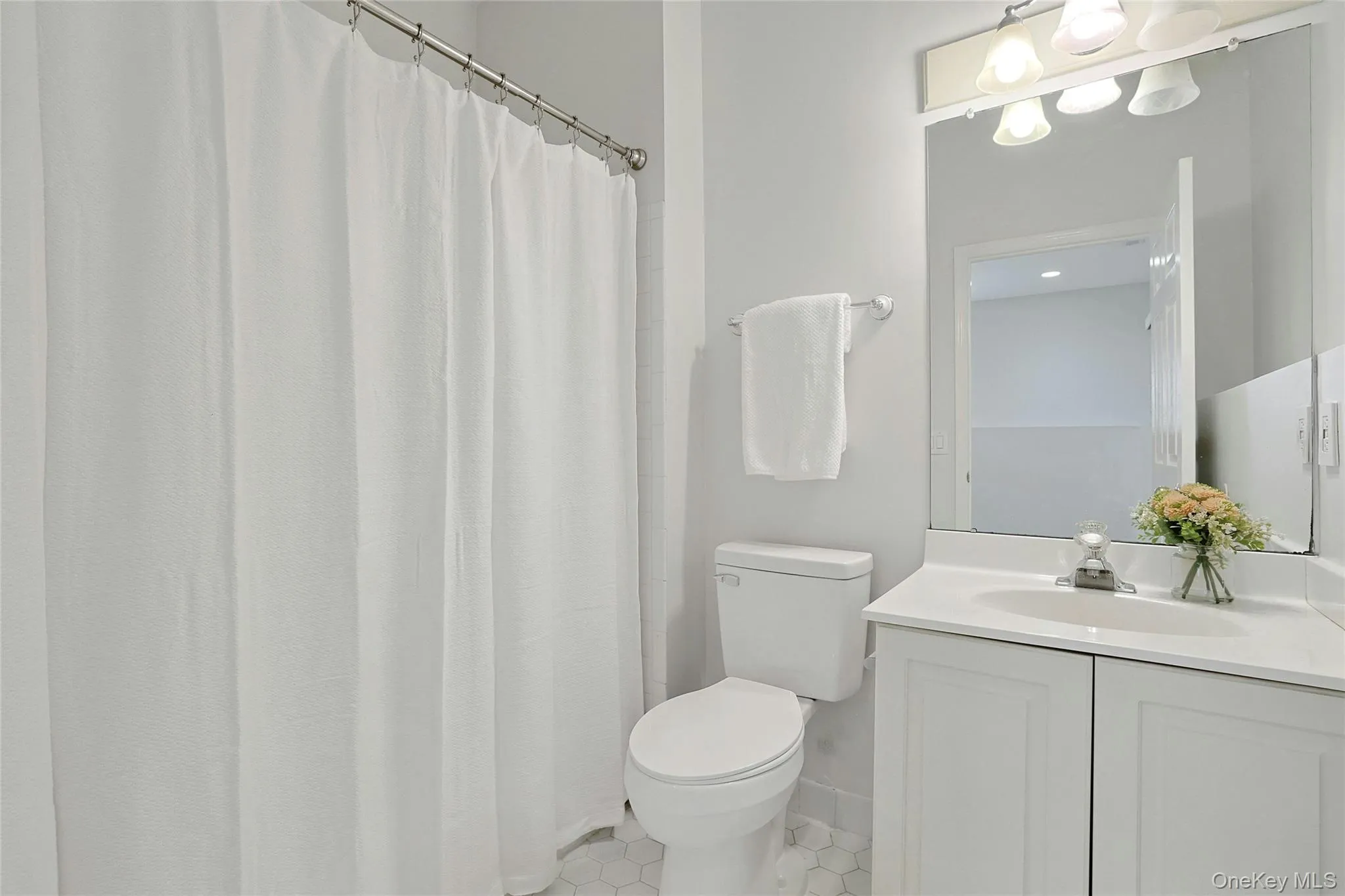 Main level full bath, with tub and lights tiles Main level full bath, with tub and lights tiles
