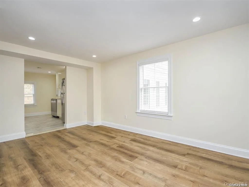 Unfurnished room with recessed lighting, light wood-style flooring, and baseboards Unfurnished room with recessed lighting, light wood-style flooring, and baseboards