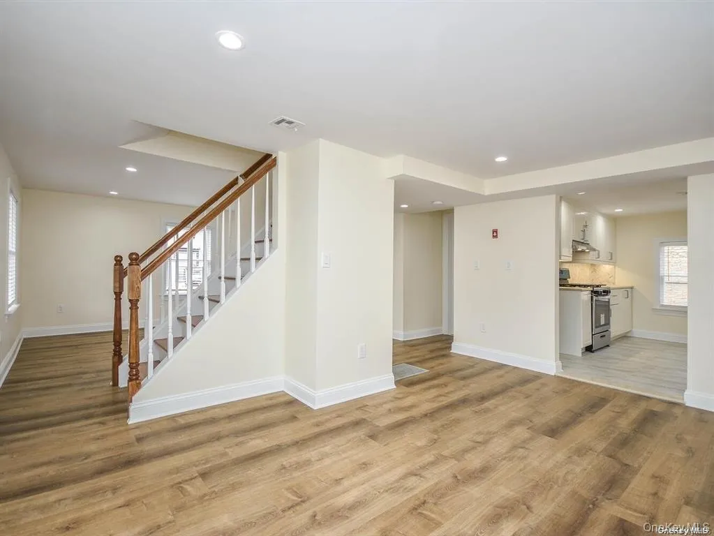 Unfurnished living room with light wood finished floors, visible vents, recessed lighting, and baseboards Unfurnished living room with light wood finished floors, visible vents, recessed lighting, and baseboards