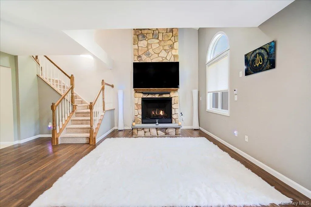 Large 2 story open living room with gas fireplace, large windows, and newer flooring. Large 2 story open living room with gas fireplace, large windows, and newer flooring.