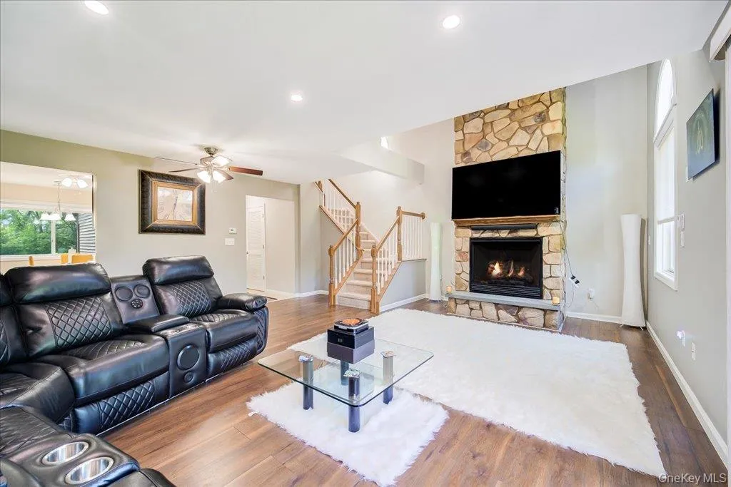 Large 2 story open living room with gas fireplace, large windows, and newer flooring. Large 2 story open living room with gas fireplace, large windows, and newer flooring.