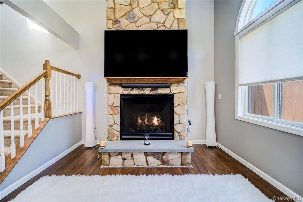 Large 2 story open living room with gas fireplace, large windows, and newer flooring. Large 2 story open living room with gas fireplace, large windows, and newer flooring.