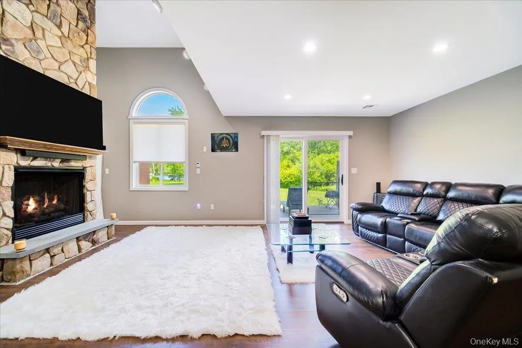 Large 2 story open living room with gas fireplace, large windows, and newer flooring. Large 2 story open living room with gas fireplace, large windows, and newer flooring.