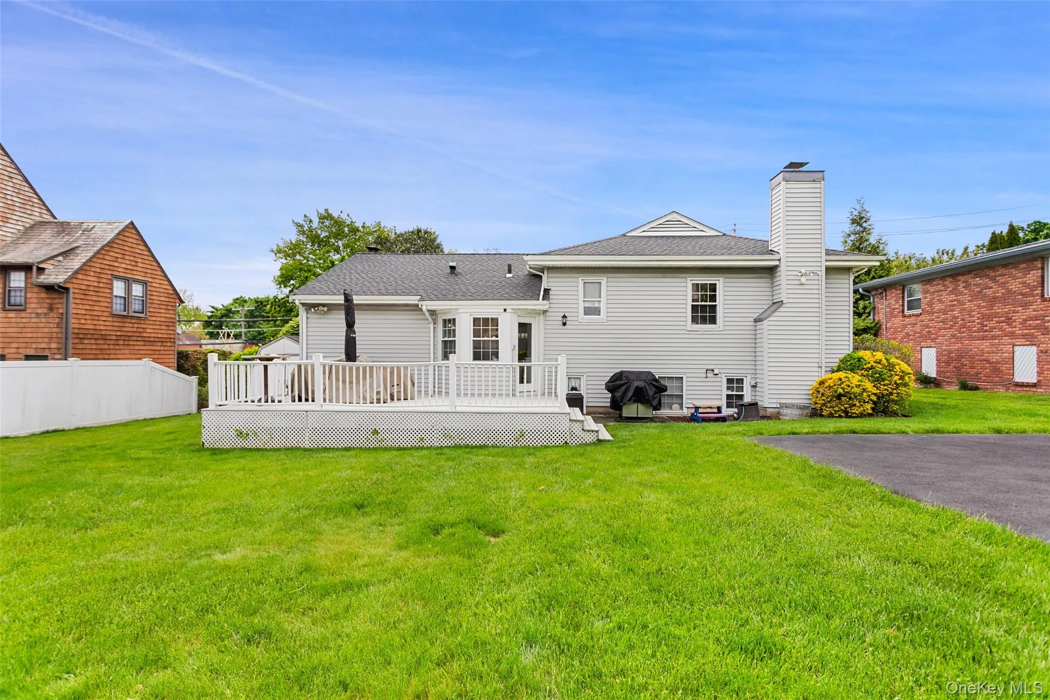 Rear exterior featuring deck and backyard. Rear exterior featuring deck and backyard.