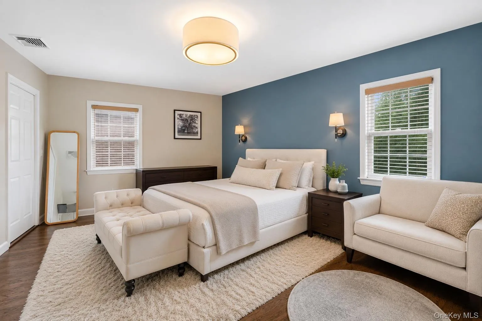 Spacious primary bedroom with hardwood flooring. Spacious primary bedroom with hardwood flooring.