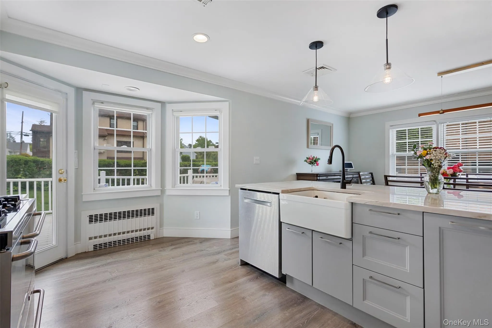 Bright kitchen with bay window and farmhouse sink. Bright kitchen with bay window and farmhouse sink.