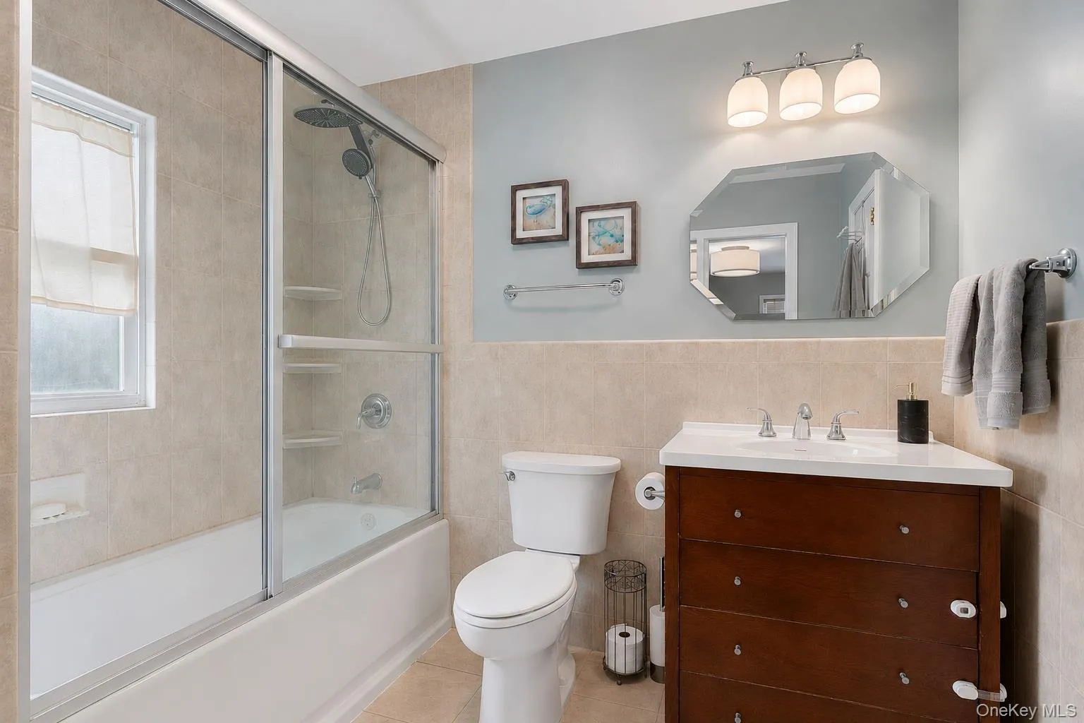 Primary bathroom with glass-enclosed shower. Primary bathroom with glass-enclosed shower.