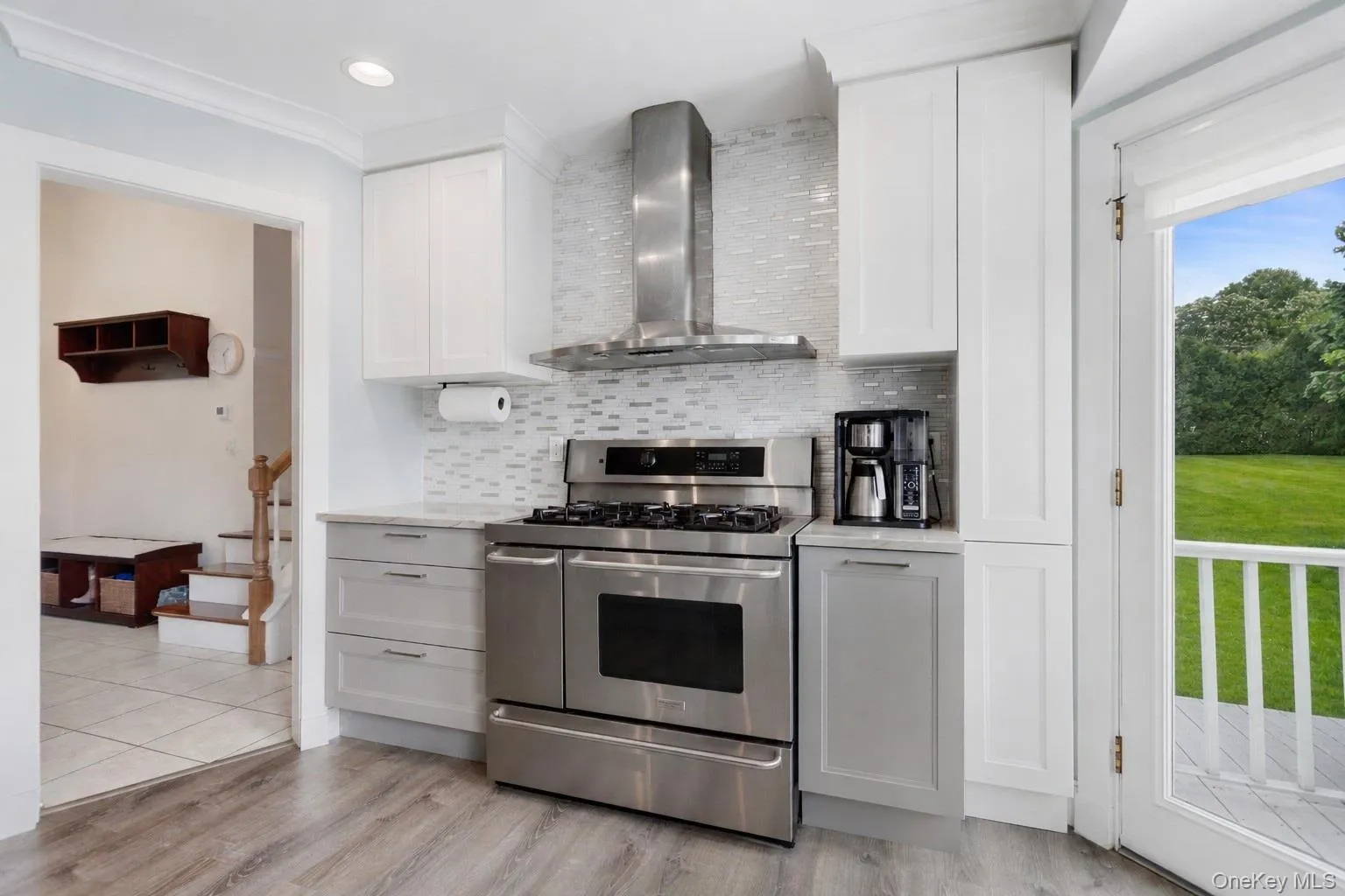 Kitchen with stainless steel range and tile backsplash. Kitchen with stainless steel range and tile backsplash.