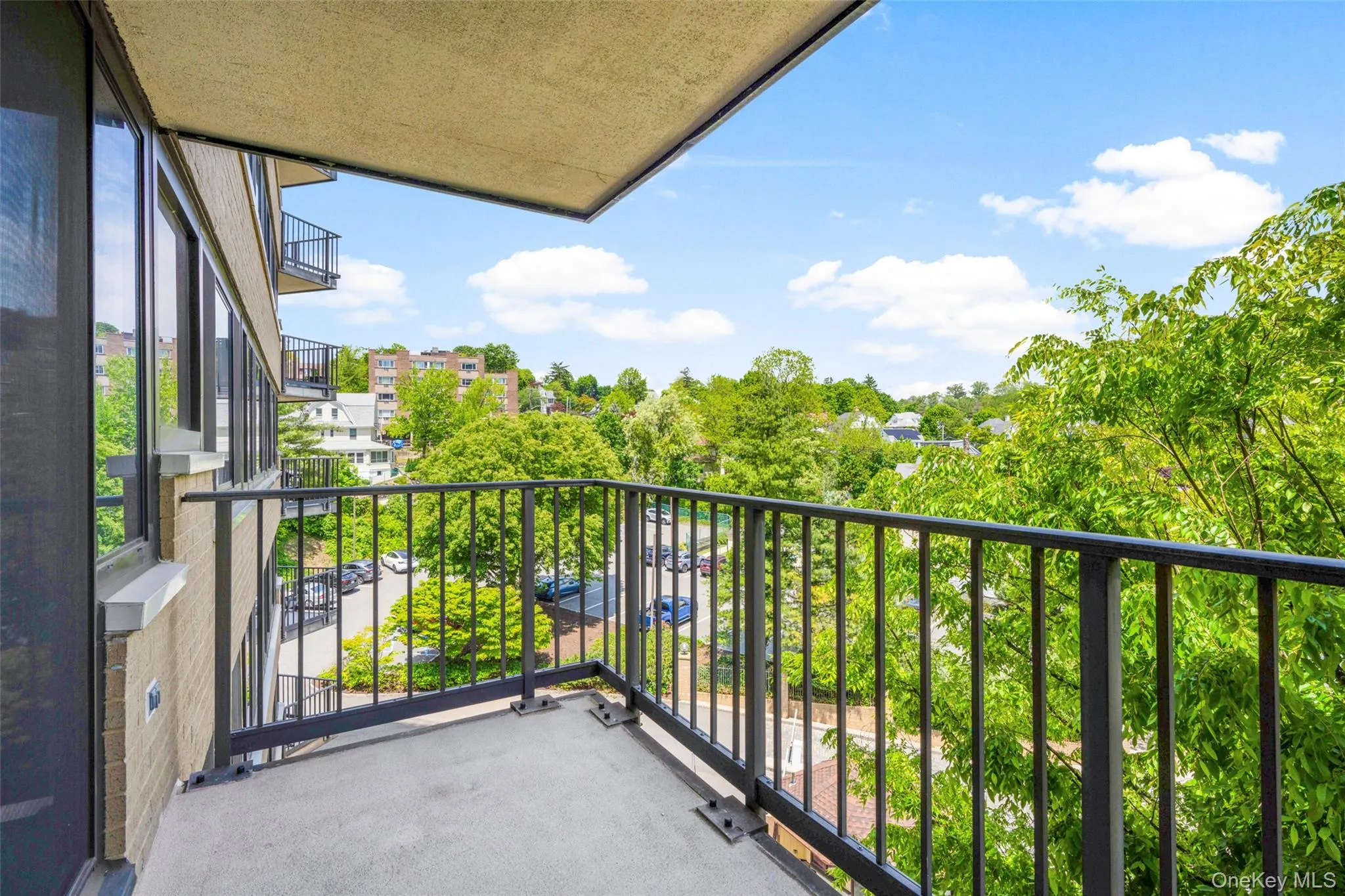 Private balcony featuring a concrete floor and black metal railing Private balcony featuring a concrete floor and black metal railing