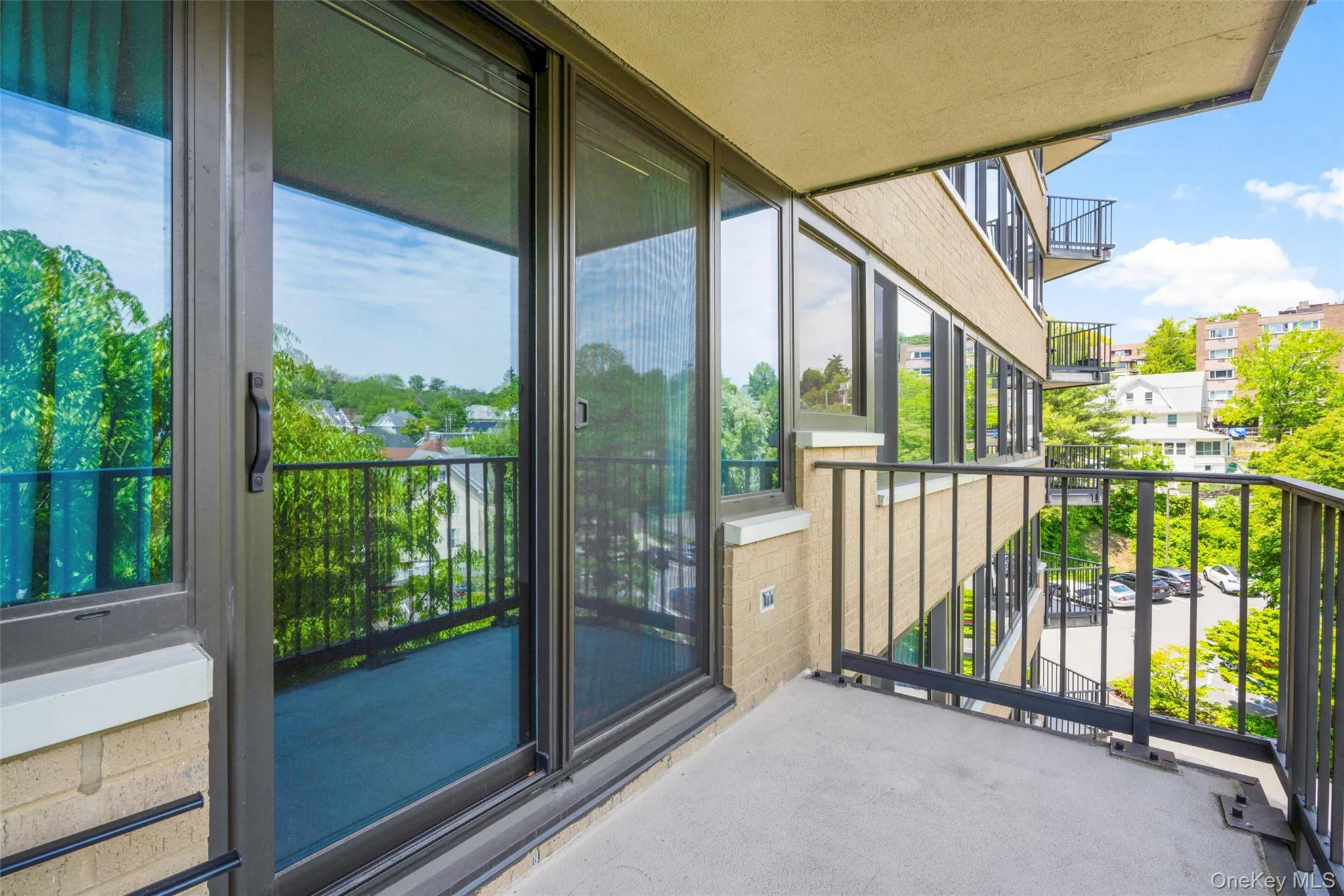 Private balcony with concrete flooring and black metal railings Private balcony with concrete flooring and black metal railings