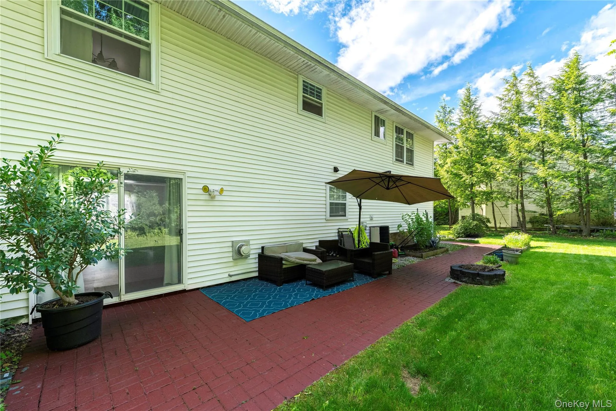 Beautiful brick patio full length of house, built in planters and fire-pit. Beautiful brick patio full length of house, built in planters and fire-pit.