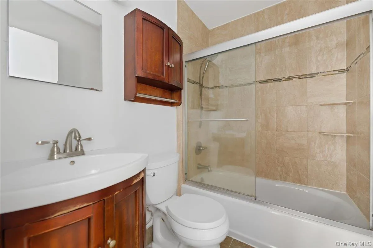 Updated Full bathroom featuring enclosed tub / shower combo and vanity Updated Full bathroom featuring enclosed tub / shower combo and vanity