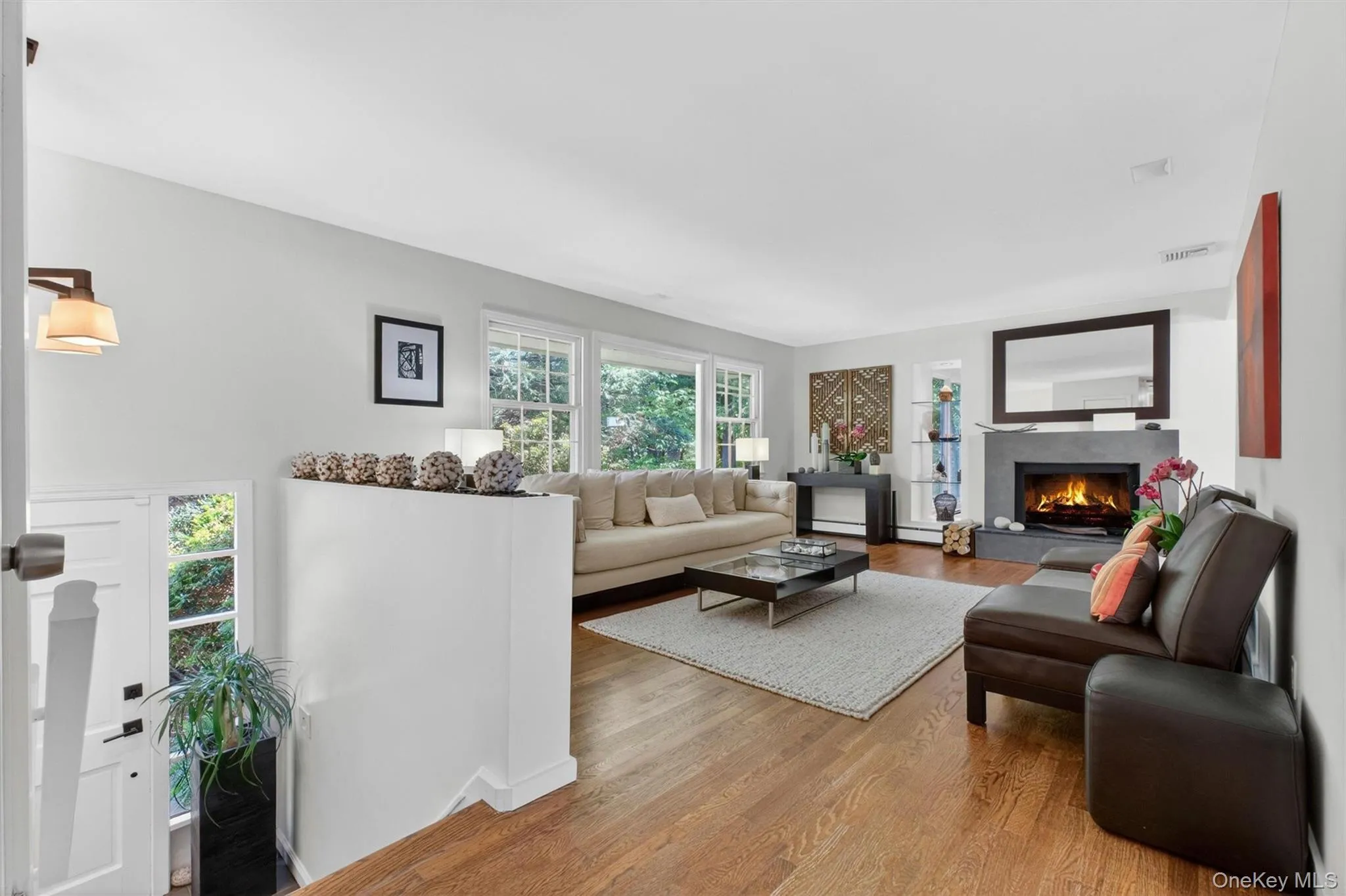 Unwind in the expansive living room featuring a dramatic double-sided fireplace and built-in shelving. Unwind in the expansive living room featuring a dramatic double-sided fireplace and built-in shelving.