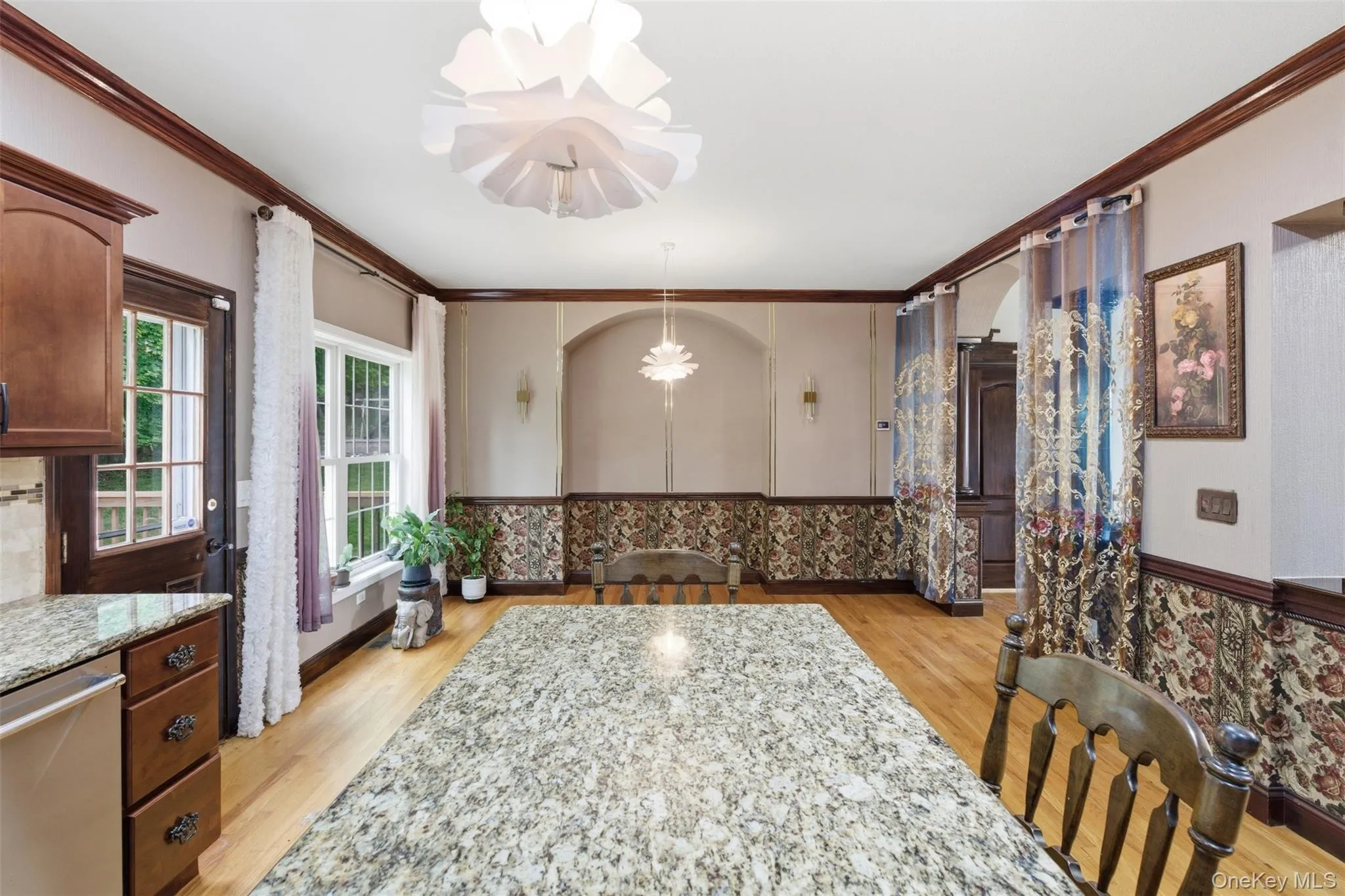 Expansive granite countertop island serving as a central feature Expansive granite countertop island serving as a central feature