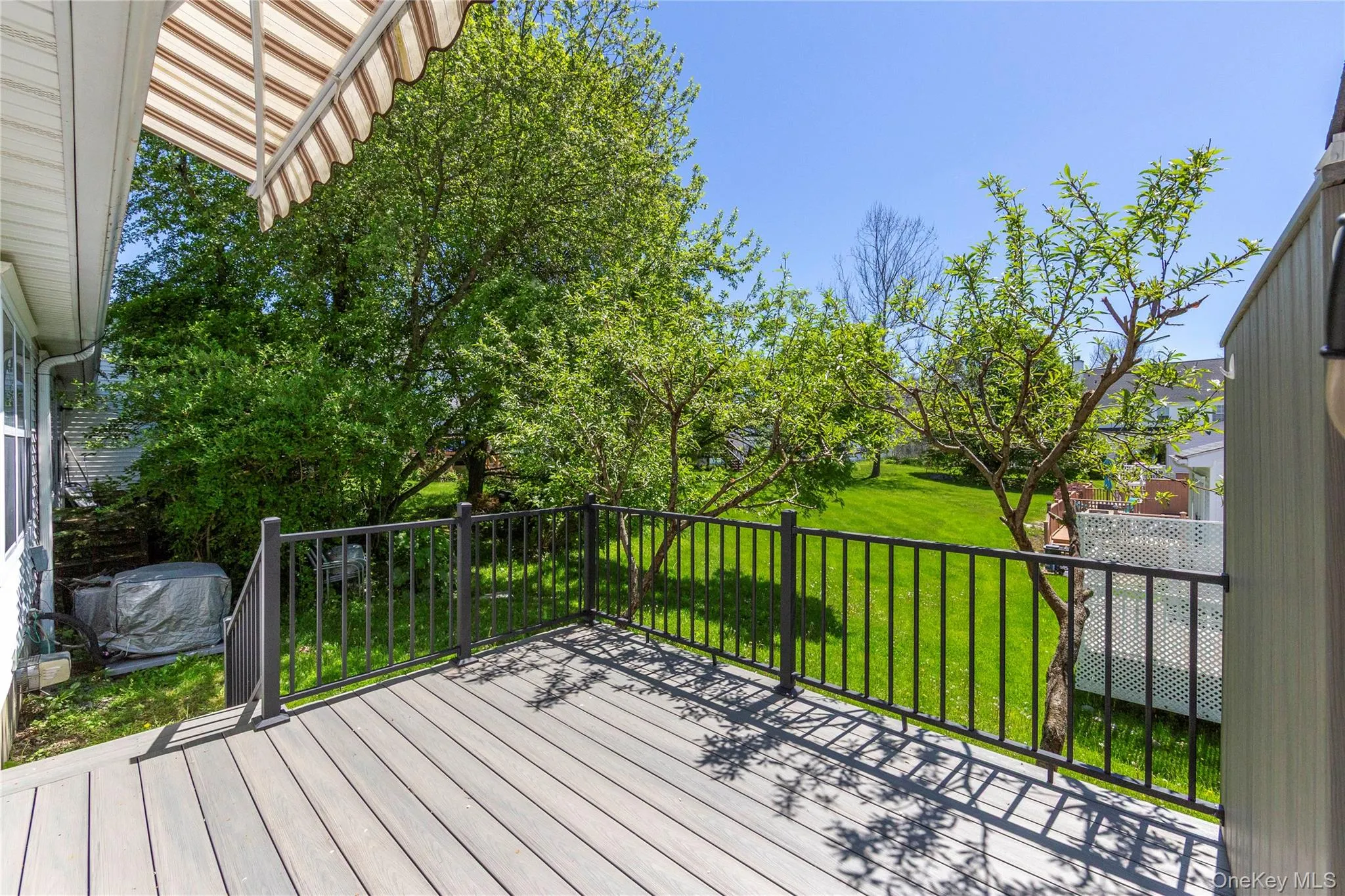 Complete with new Trex decking, stylish black railings, and an awning for shade. Complete with new Trex decking, stylish black railings, and an awning for shade.