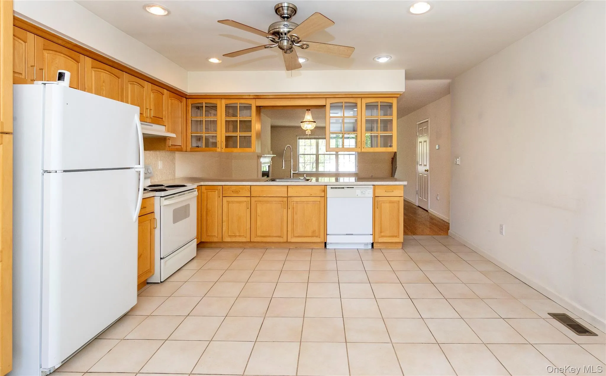 The double sided upper glass cabinetry adds to the open feel between the kitchen, dining and living room. The double sided upper glass cabinetry adds to the open feel between the kitchen, dining and living room.