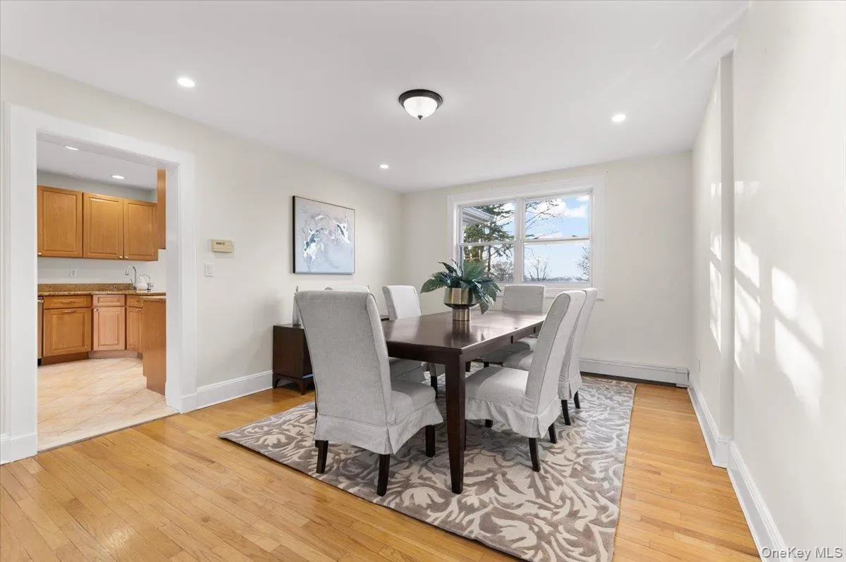 Dining area with light wood finished floors, recessed lighting, and a baseboard radiator Dining area with light wood finished floors, recessed lighting, and a baseboard radiator
