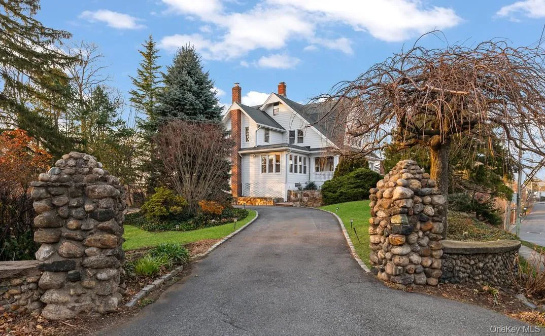 View of front of property with a chimney and a front yard View of front of property with a chimney and a front yard
