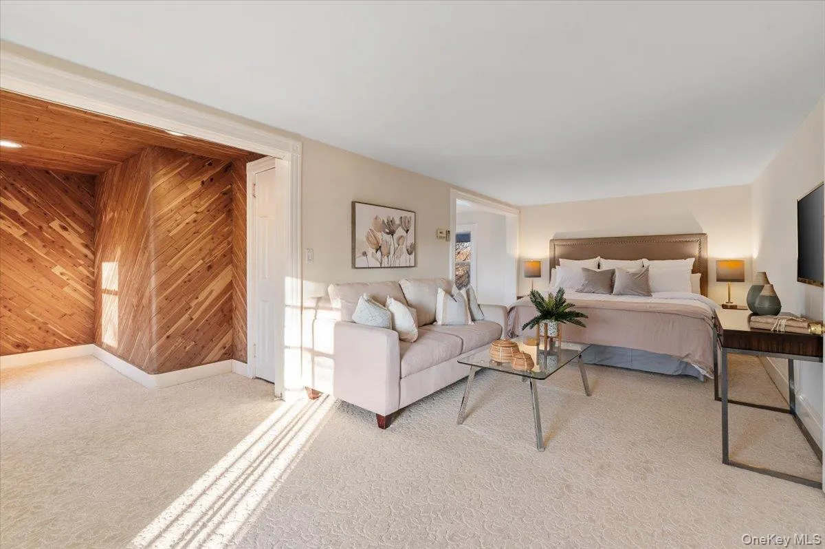 Bedroom featuring wooden walls and carpet Bedroom featuring wooden walls and carpet