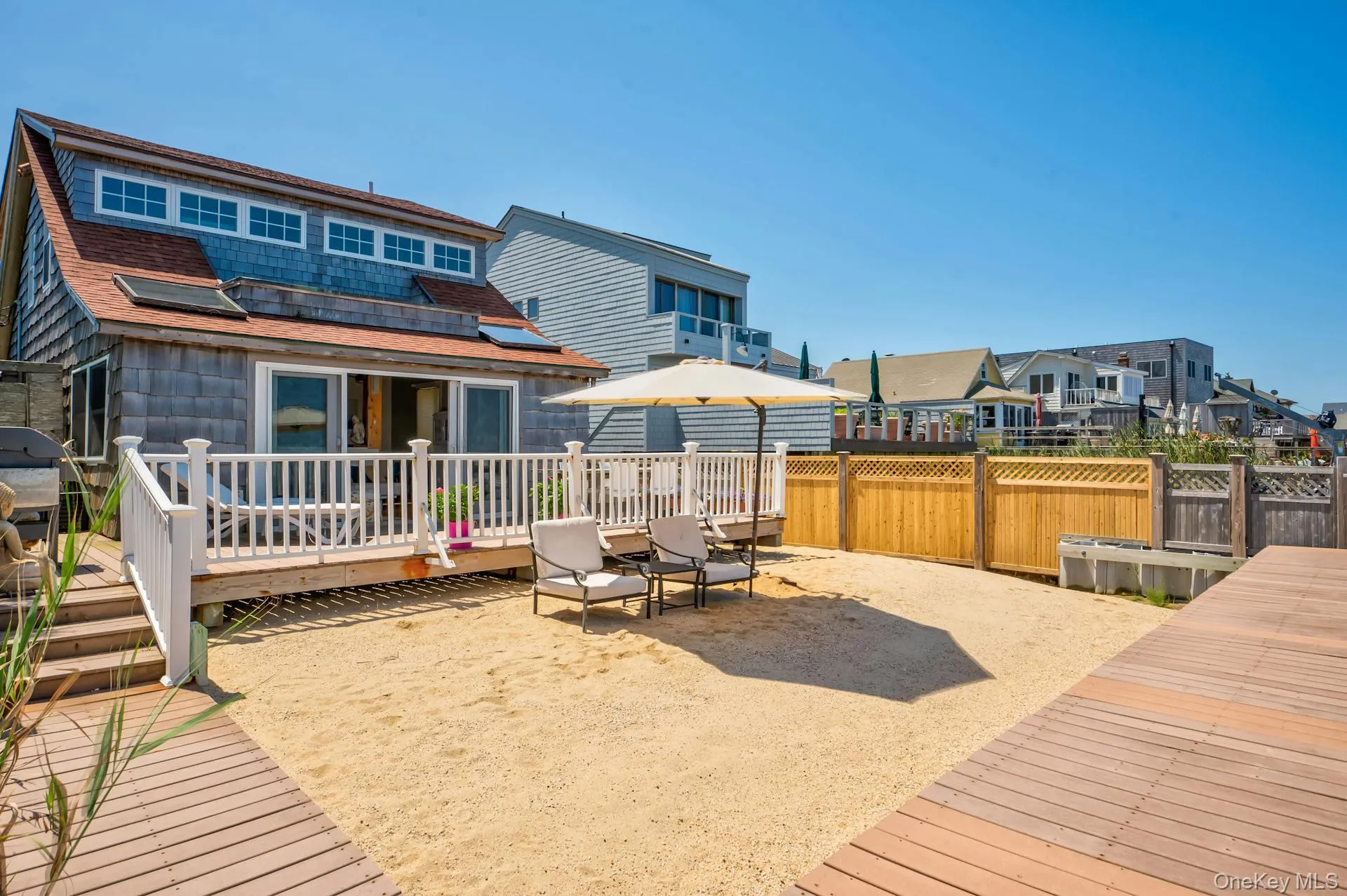 Waterfront property with a shingle-sided exterior and a red-toned roof Waterfront property with a shingle-sided exterior and a red-toned roof