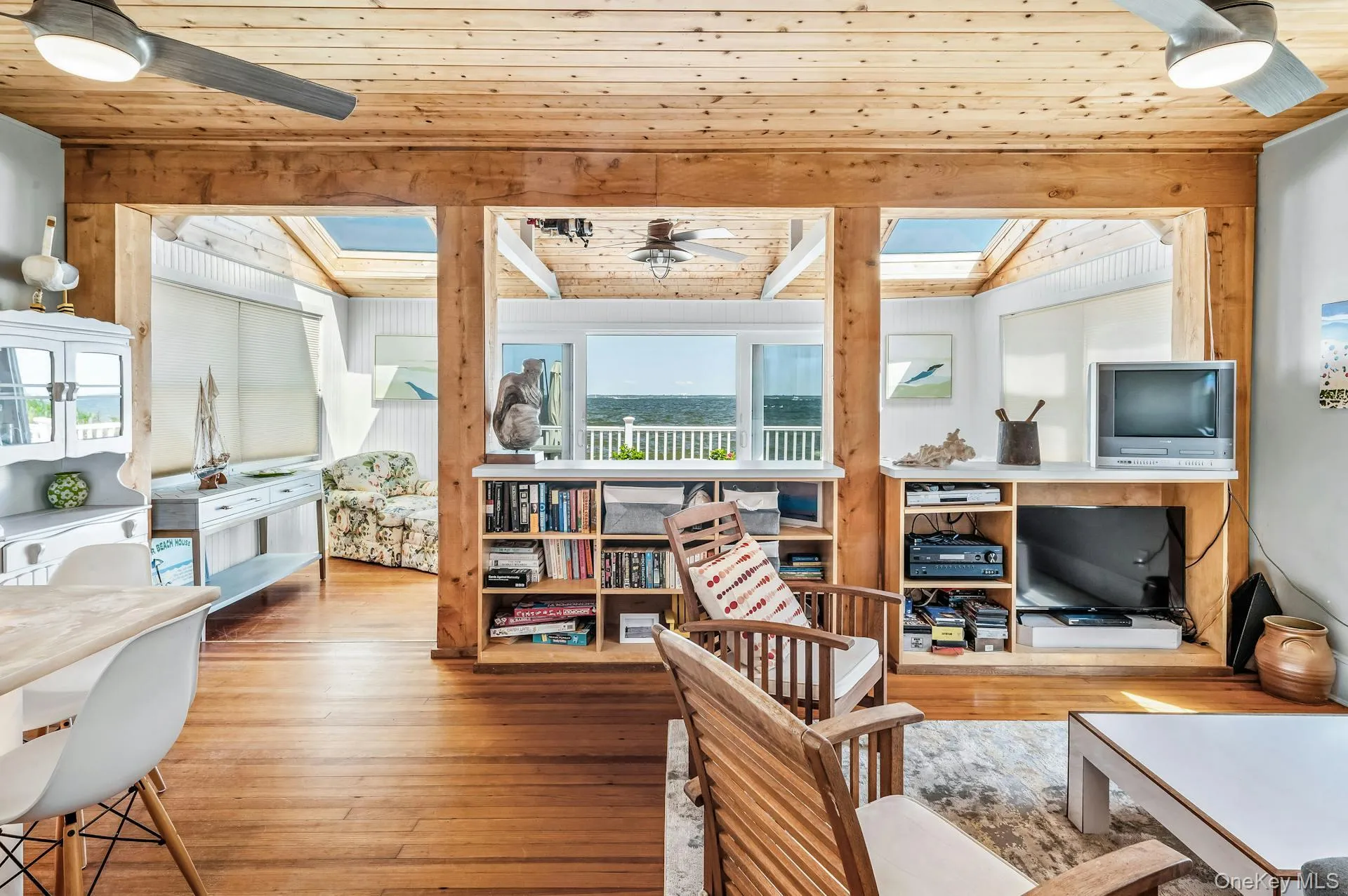 Interior featuring wood-finish flooring, exposed wood beams, and a wood plank ceiling Interior featuring wood-finish flooring, exposed wood beams, and a wood plank ceiling